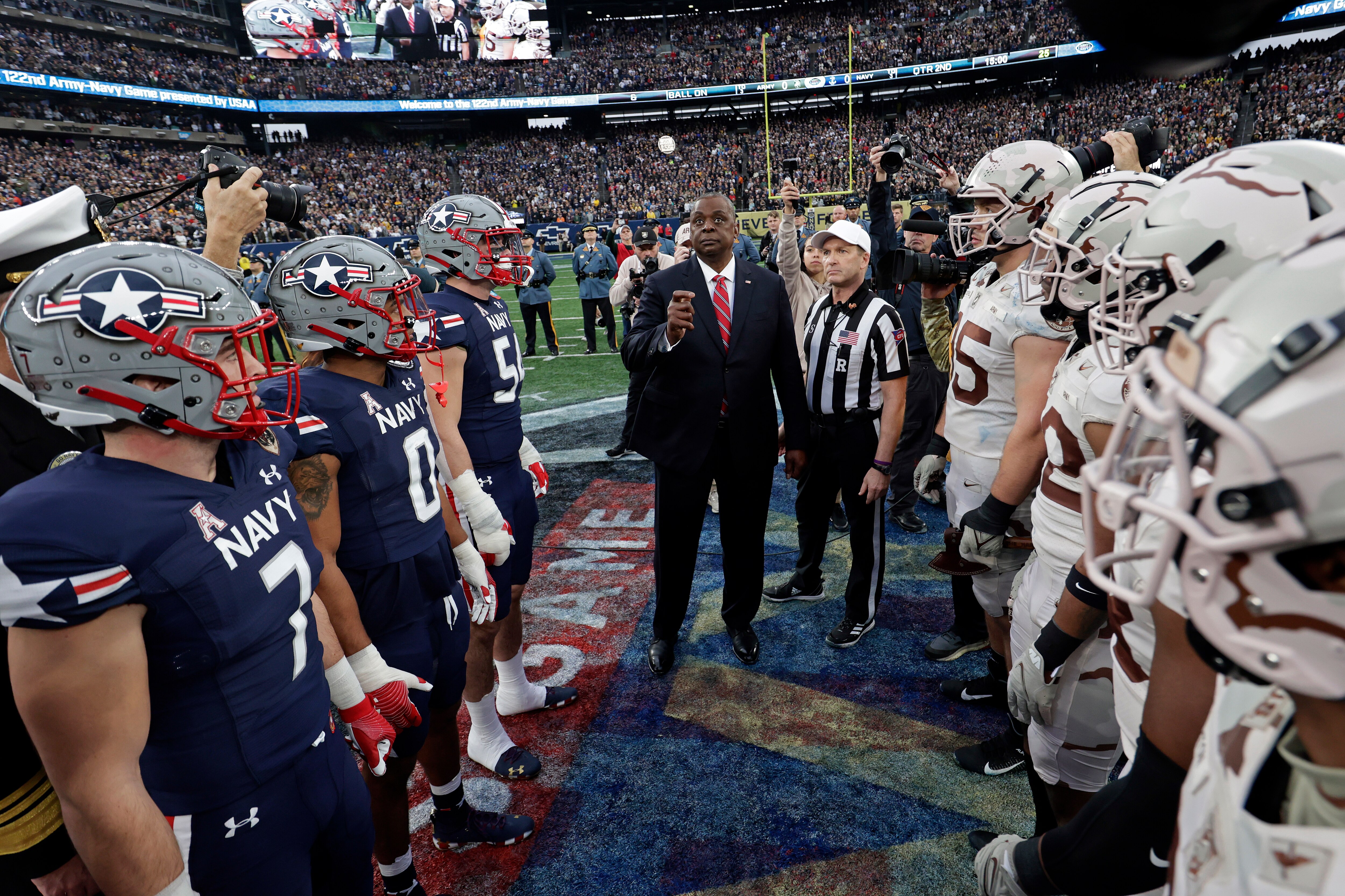Army and Navy team captains line up for the coin toss before the game in 2021.