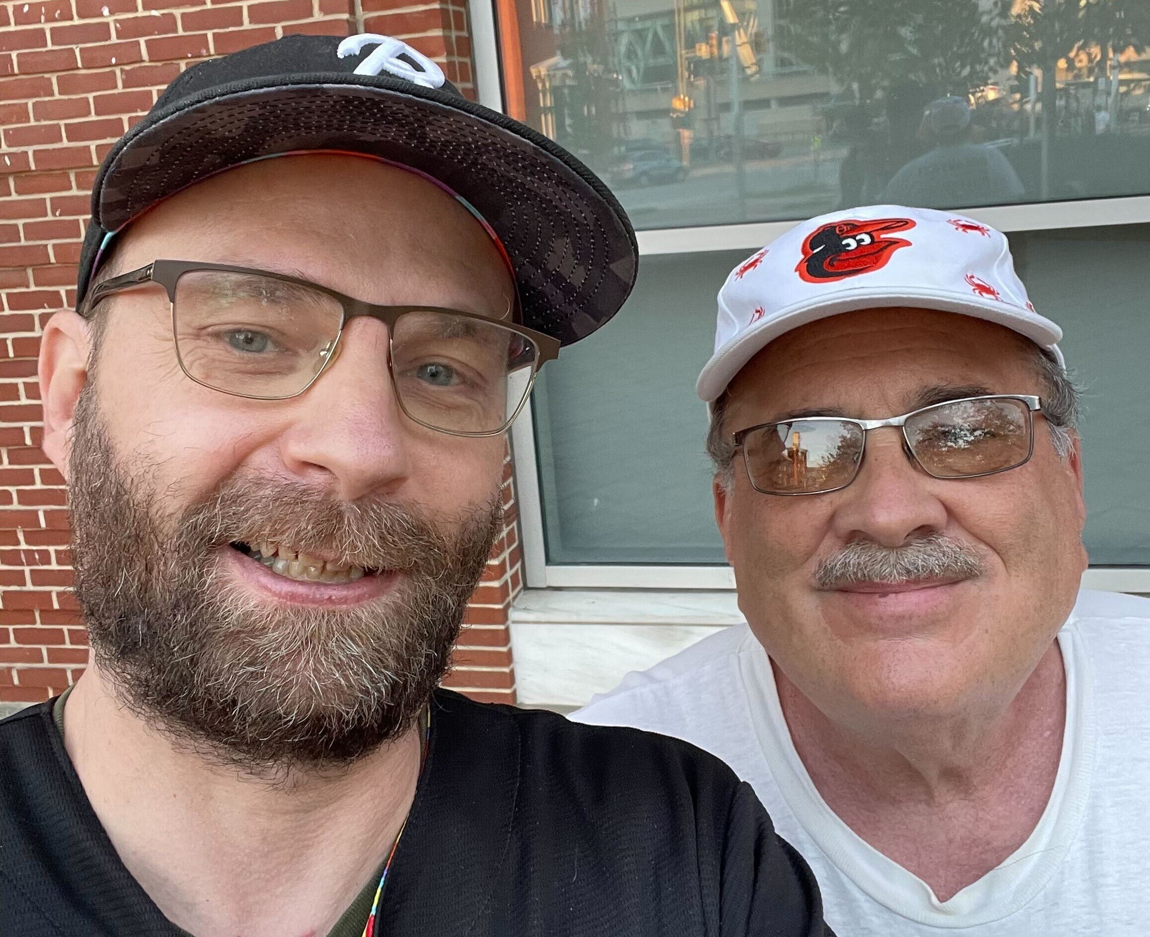Andy Ellis, left, and Bill Marker are Orioles fans and civic activists who have mounted a campaign to convince Baltimore leaders to consider using eminent domain to seize ownership of the baseball team and either sell the team or turn it into a publicly-owned organization.