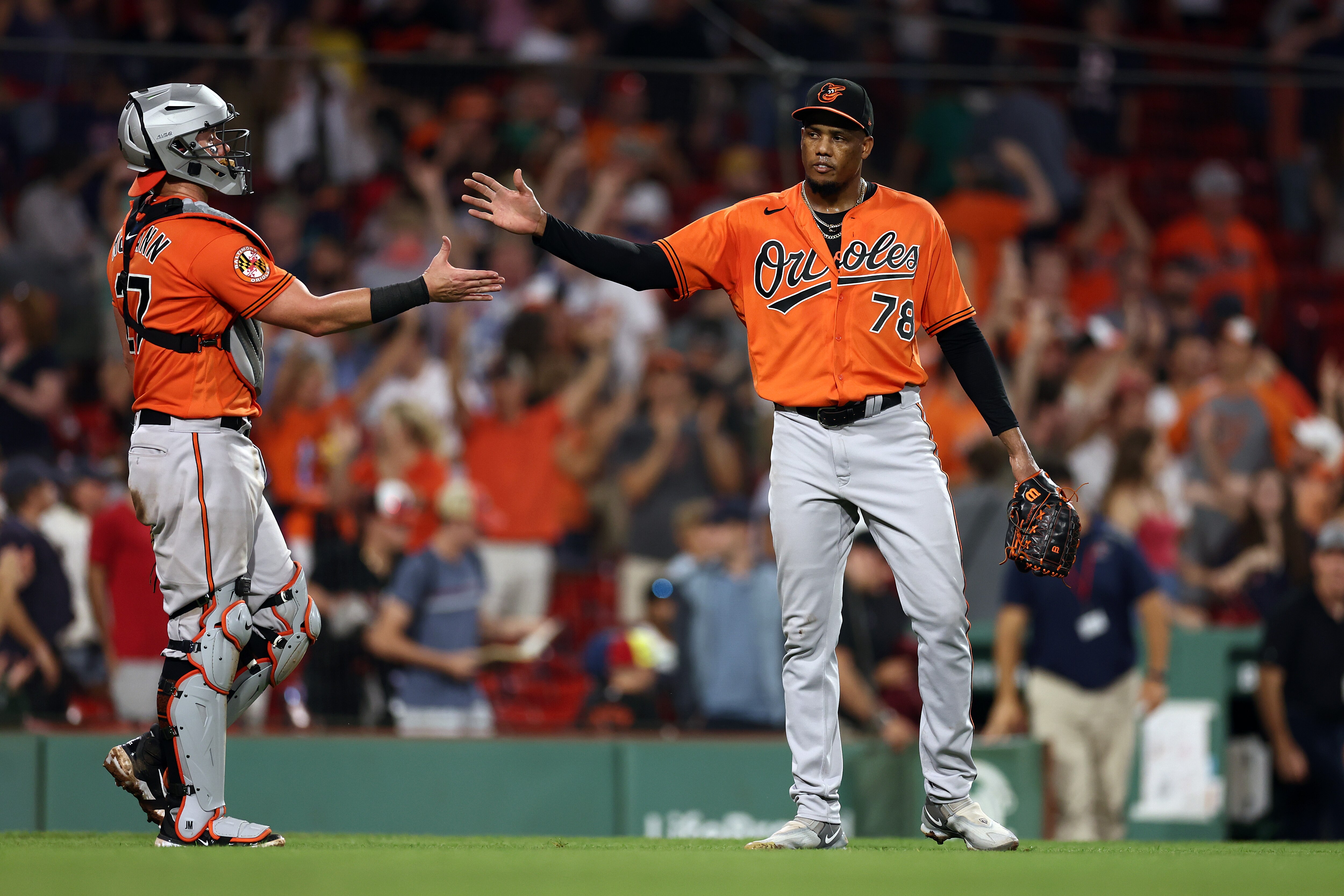 BOSTON, MASSACHUSETTS - SEPTEMBER 09: Yennier Cano #78 of the Baltimore Orioles and James McCann #27 celebrate after defeating the Boston Red Sox 13-12 at Fenway Park on September 09, 2023 in Boston, Massachusetts. (Photo by Maddie Meyer/Getty Images)