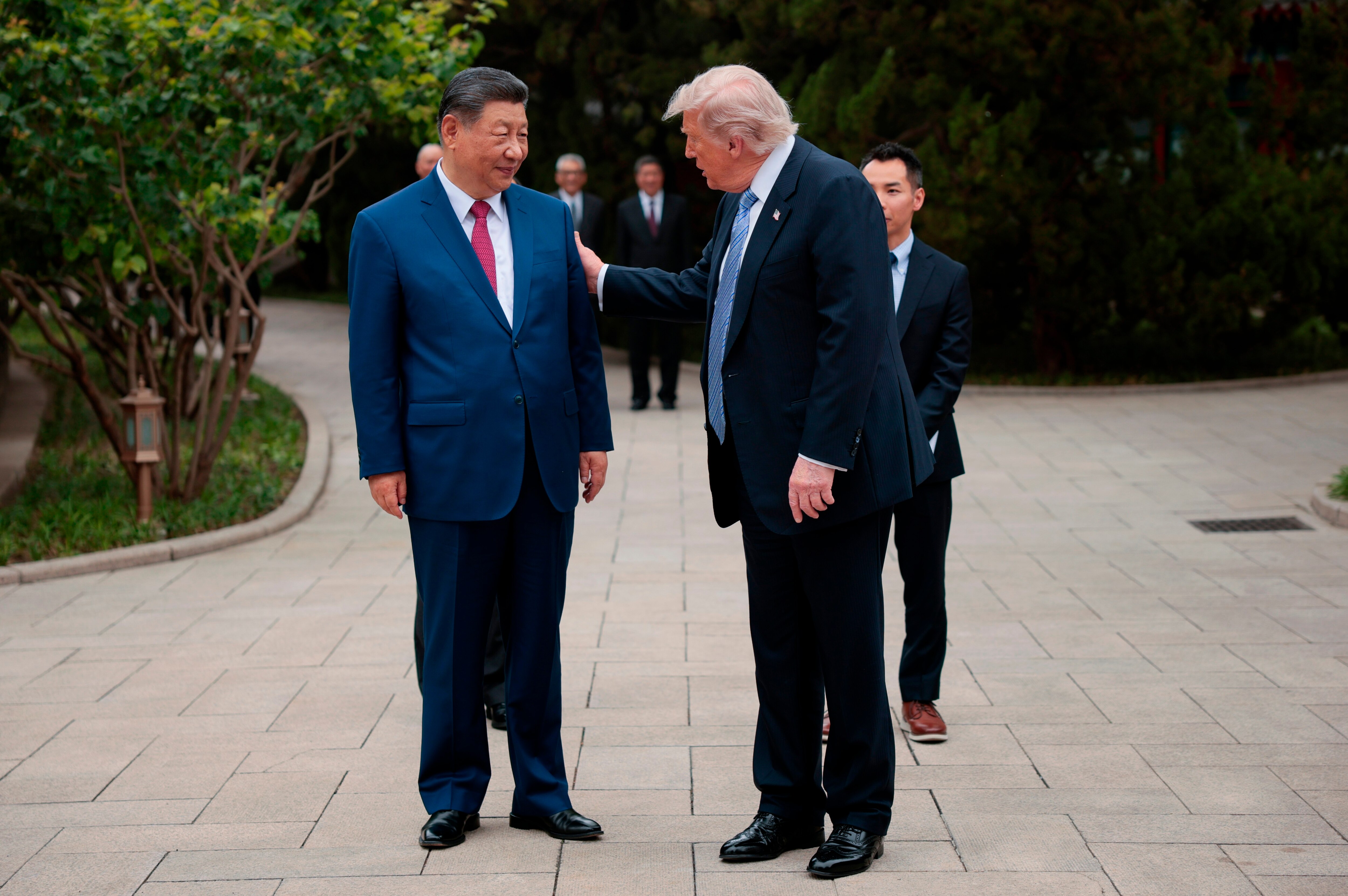 President Donald Trump speaks with Chinese President Xi Jinping, left, while leaving after a visit to the Zhongnanhai Garden in Beijing, Friday, May 15, 2026.