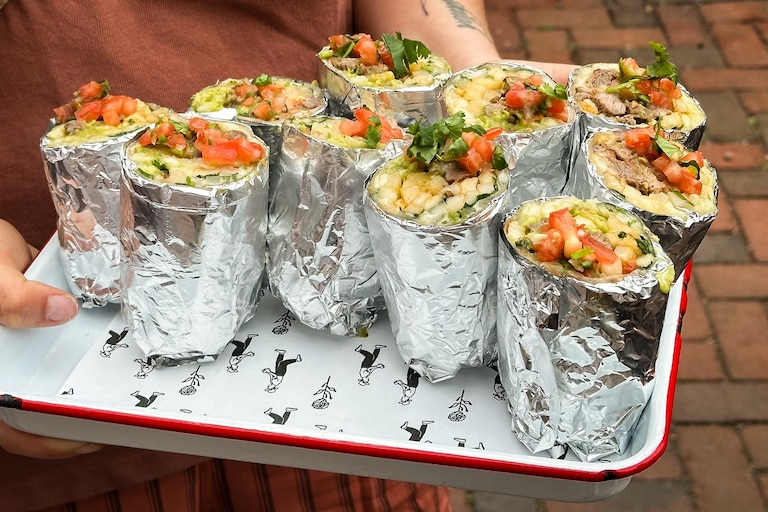 San Pancho co-owner Carolina McCandless serves up mini versions of the restaurant’s famous San Francisco-style breakfast burritos.