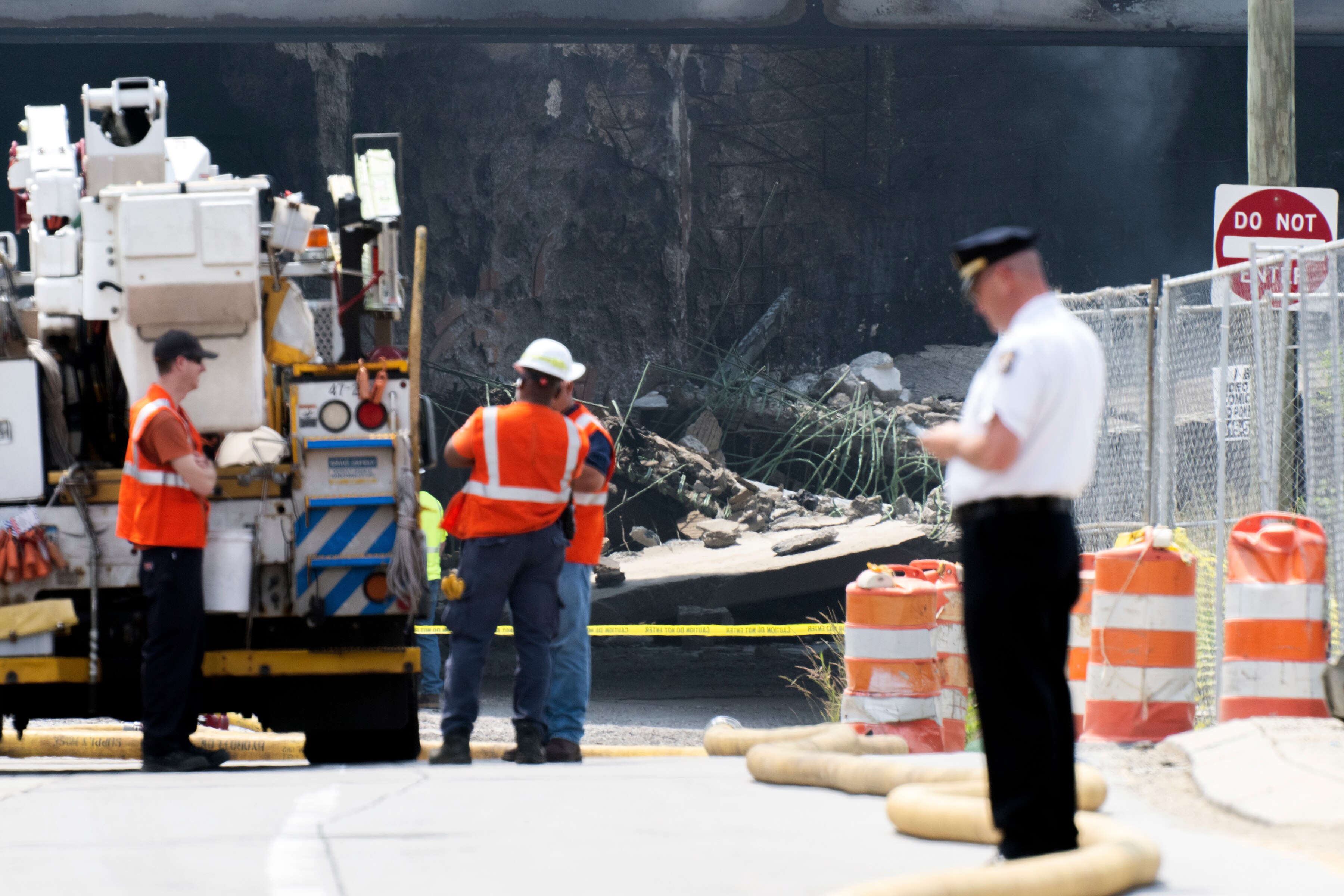 Officials work on the scene following a collapse on I-95 after a truck fire, Sunday, June 11, 2023 in Philadelphia. (AP Photo/Joe Lamberti)
