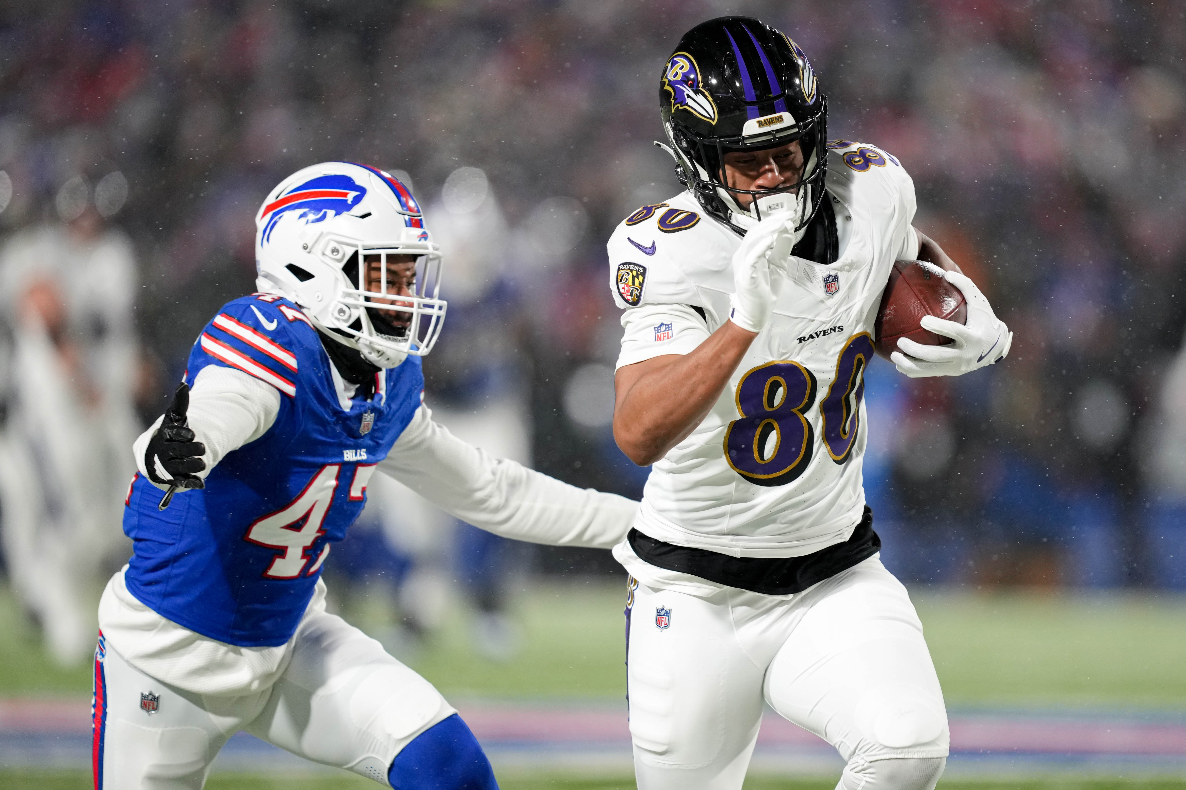 Baltimore Ravens tight end Isaiah Likely (80) runs from Buffalo Bills cornerback Christian Benford (47) after catching a pass in a divisional round playoff game at Highmark Stadium in Orchard Park, NY. on Sunday, January 19, 2025.