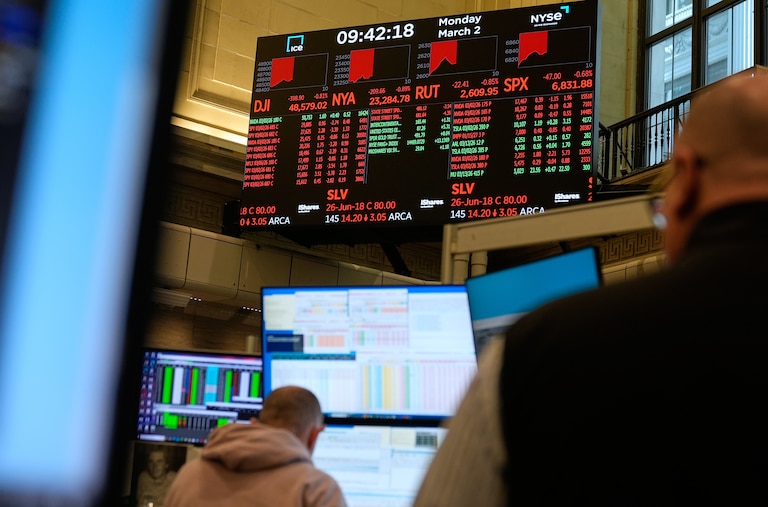 Traders work on the floor at the New York Stock Exchange in New York, Monday, March 2, 2026. (AP Photo/Seth Wenig)