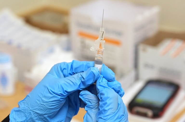 A pharmacist prepares to administer a dose of seasonal flu vaccine to a patient at a CVS Pharmacy in Miami, Tuesday, Sept. 9, 2025.