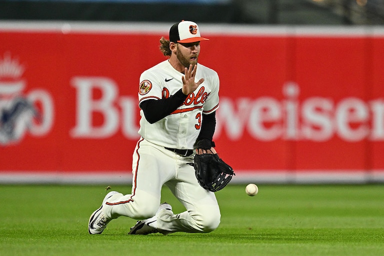 Orioles outfielder Taylor Ward tries to trap a short fly ball in the ninth inning against the Texas Rangers on March 30.