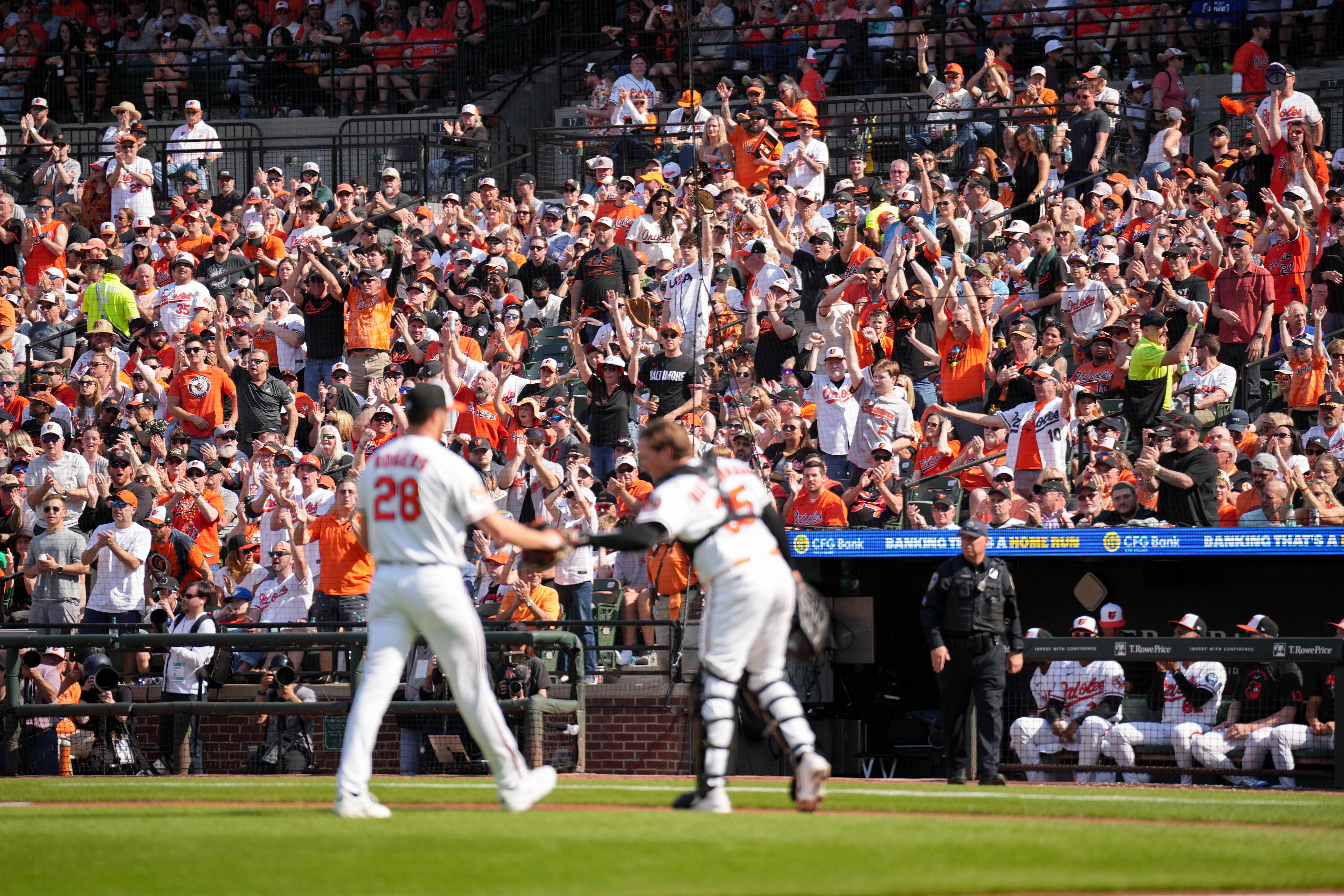 Orioles pitcher Trevor Rogers (28) fist bumps catcher Adley Rutschman (35) as the crowd cheers them on opening day at Camden Yards.