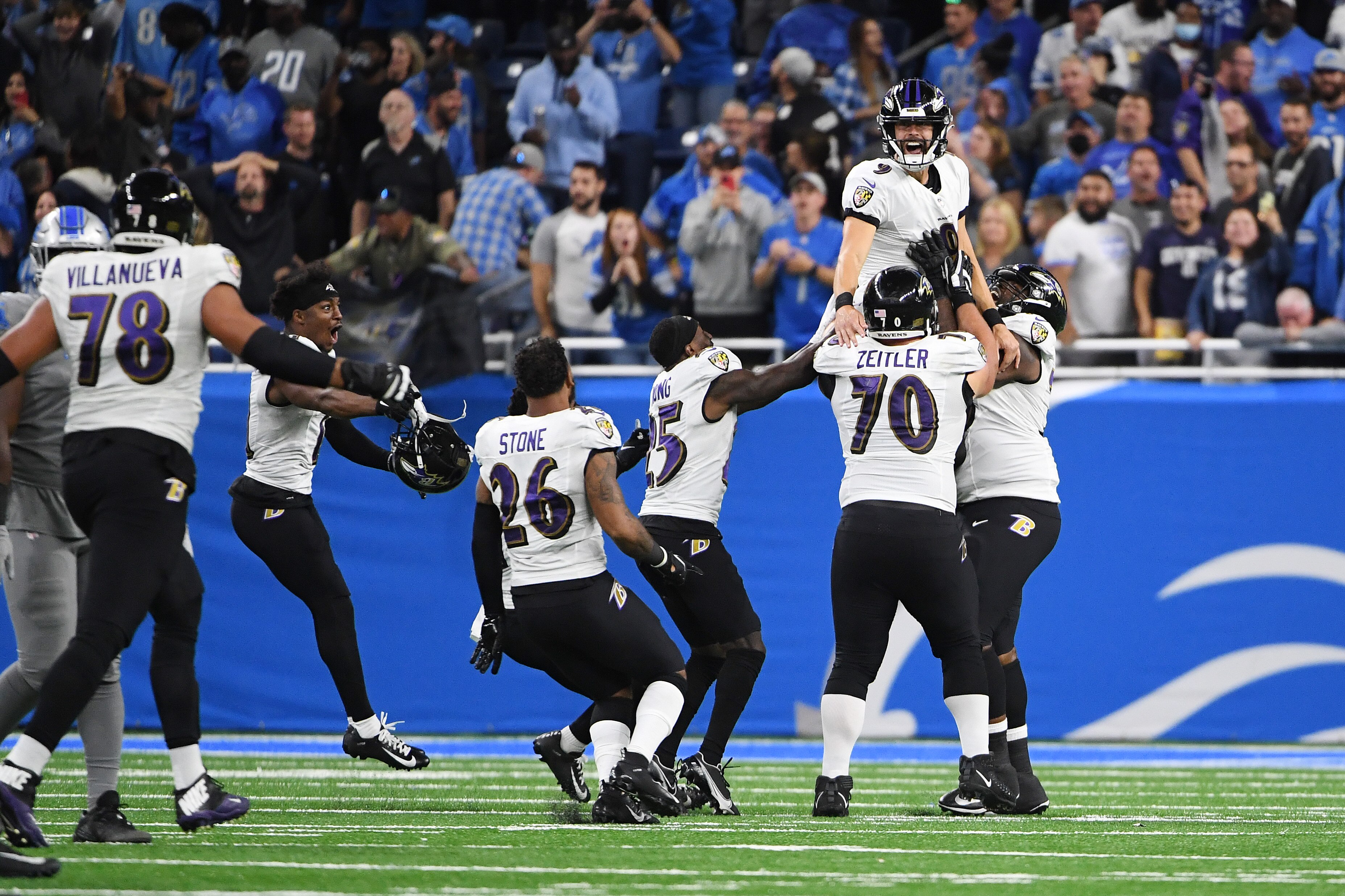 Justin Tucker and the Ravens celebrate the winning field goal against the Detroit Lions at Ford Field on Sept. 26, 2021.