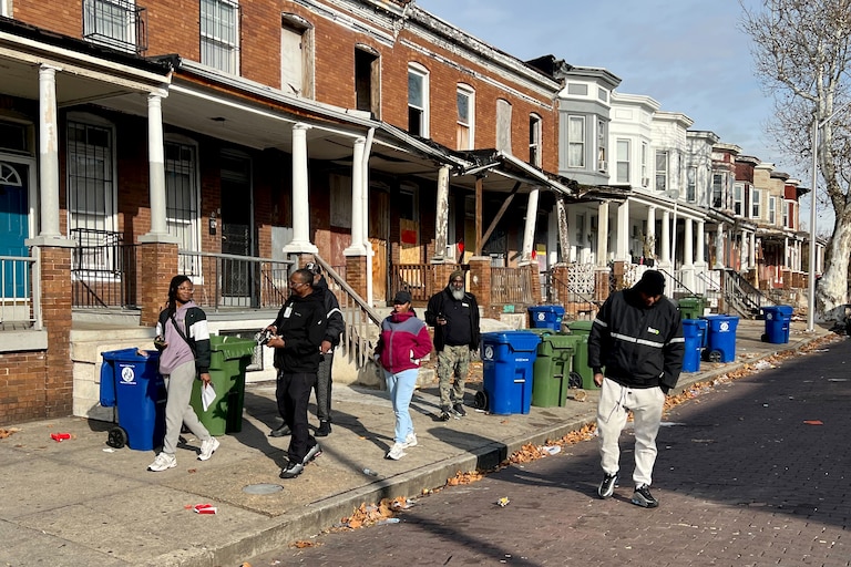 Staff with the anti-violence nonprofit Roca canvass the 2000 block of Robb Street in East Baltimore in December.