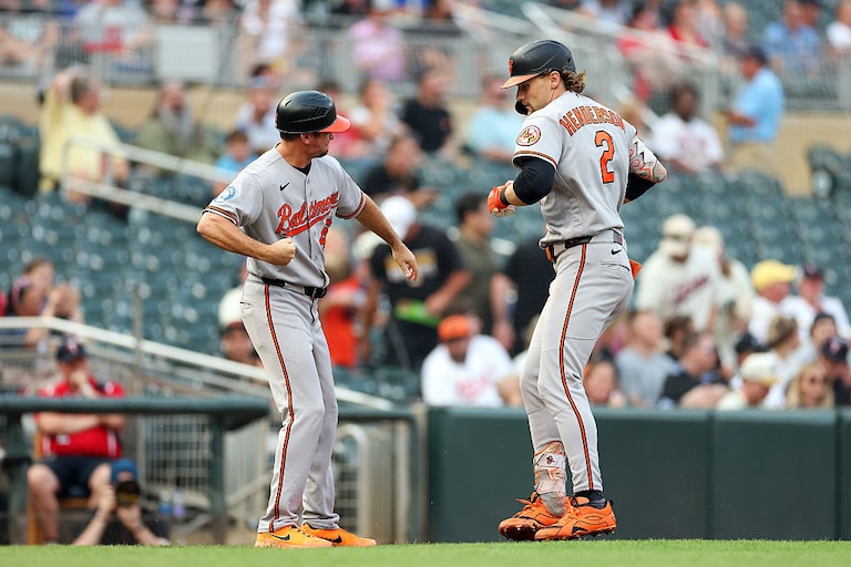 Gunnar Henderson celebrates his two-run home run with third base coach Buck Britton as he rounds the bases in the second inning.