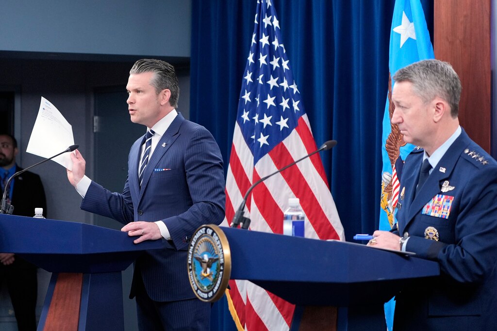 Defense Secretary Pete Hegseth and Joint Chiefs Chairman Gen. Dan Caine speak during a news conference at the Pentagon in Washington.