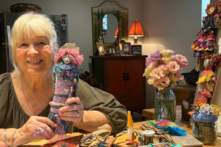 Lois Sumser holding her newest “spirit woman doll”.