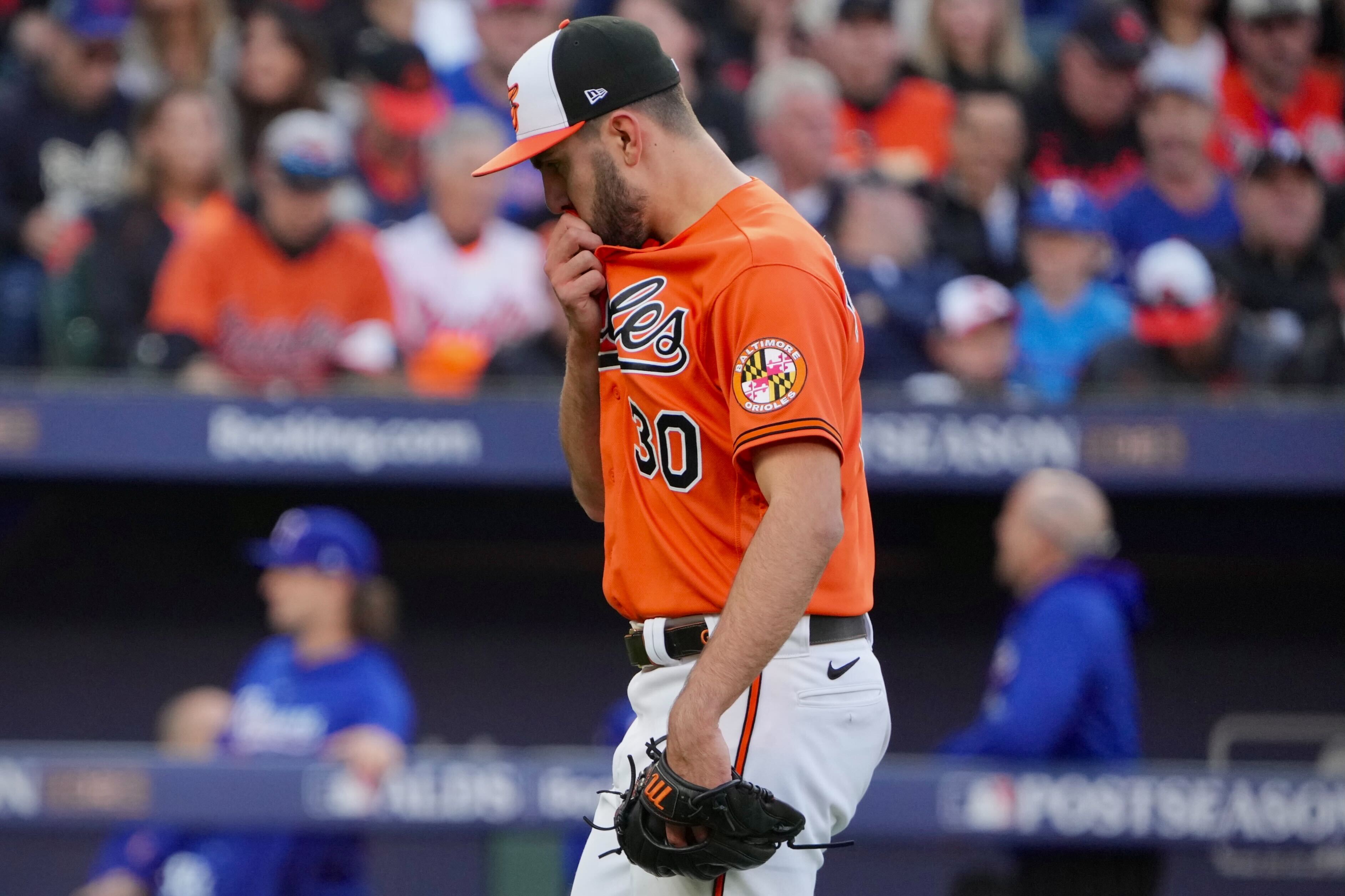Orioles pitcher Grayson Rodriguez walks to the dugout after being pulled in the second inning against the Texas Rangers in Game 2 of the ALDS at Camden Yards.