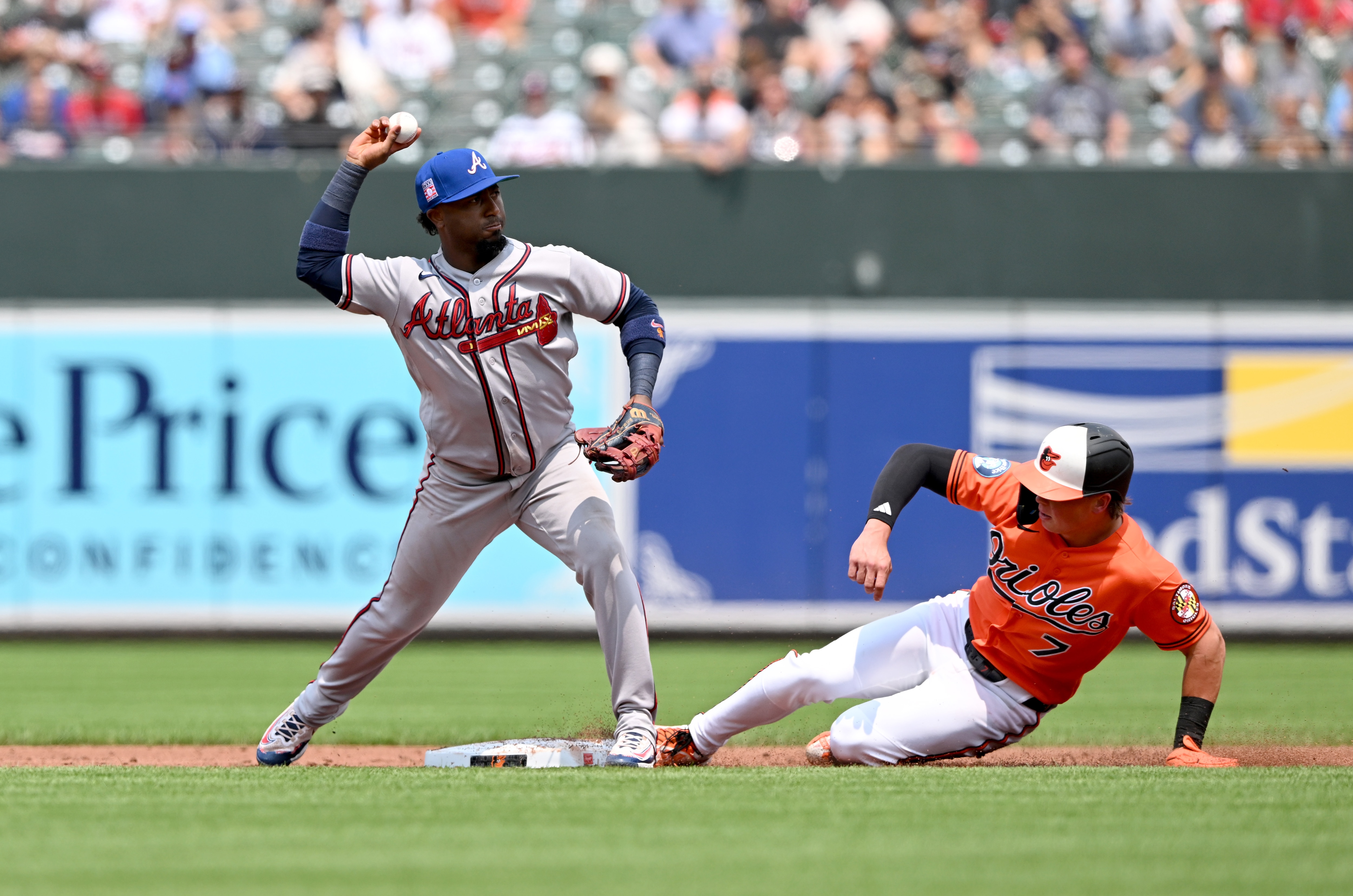 Ozzie Albies of the Braves forces out Jackson Holliday at second base to start a double play in the second inning Sunday at Camden Yards.
