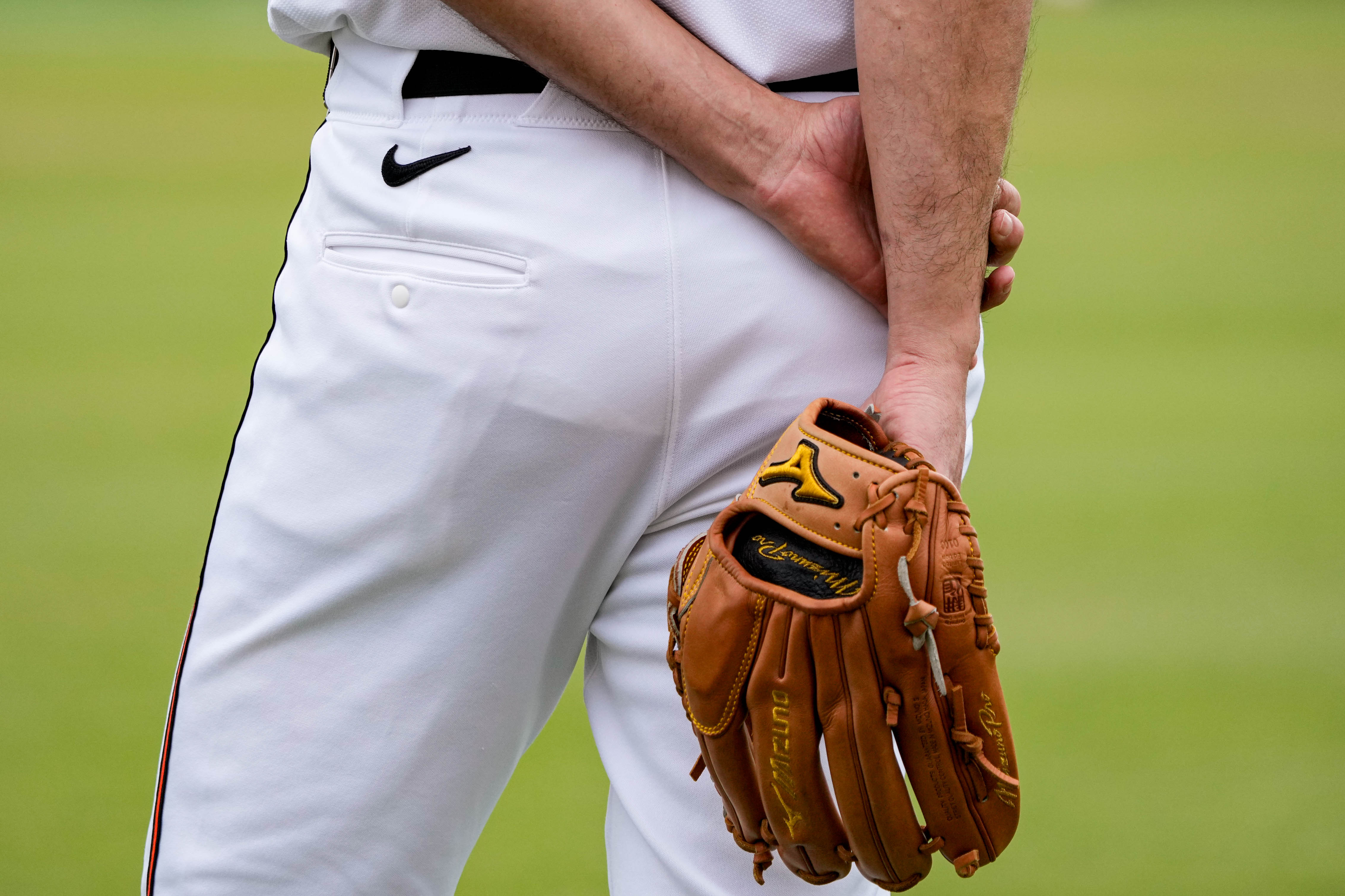 Baltimore Orioles pitcher Charlie Morton (50) holds his glove behind his back as he observes teammates warming up during Spring Training at Ed Smith Stadium in Sarasota, Fla. on Saturday, February 22, 2025.