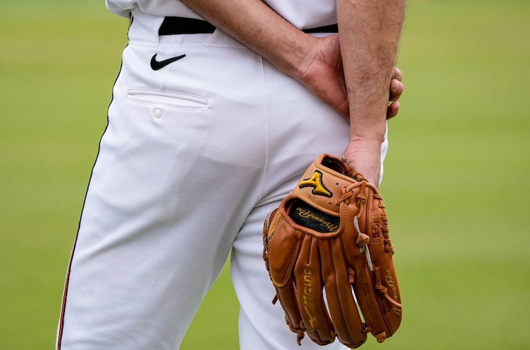 Baltimore Orioles pitcher Charlie Morton (50) holds his glove behind his back as he observes teammates warming up during Spring Training at Ed Smith Stadium in Sarasota, Fla. on Saturday, February 22, 2025.
