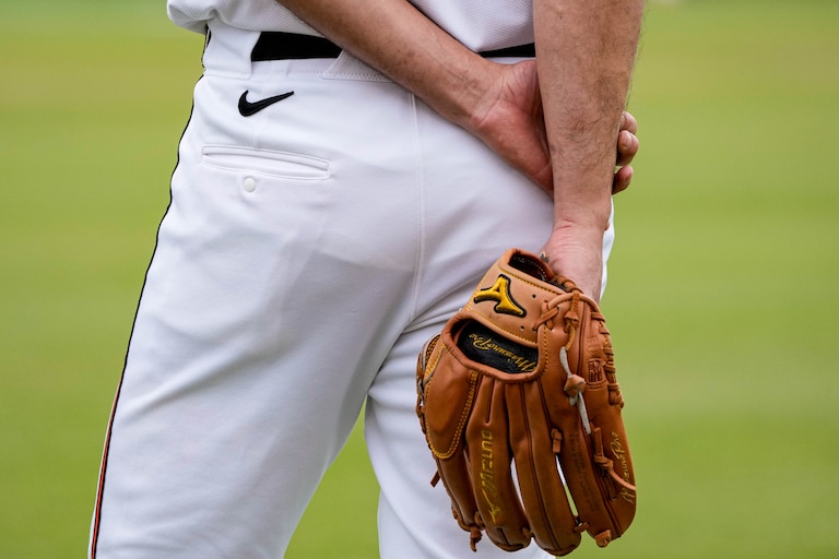 Baltimore Orioles pitcher Charlie Morton (50) holds his glove behind his back as he observes teammates warming up during Spring Training at Ed Smith Stadium in Sarasota, Fla. on Saturday, February 22, 2025.