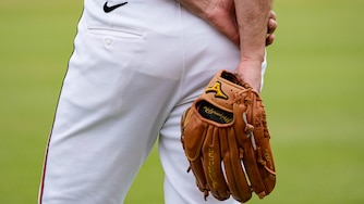 Baltimore Orioles pitcher Charlie Morton (50) holds his glove behind his back as he observes teammates warming up during Spring Training at Ed Smith Stadium in Sarasota, Fla. on Saturday, February 22, 2025.