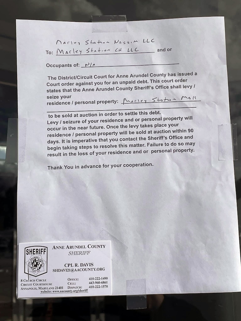 A picture of the notice warning of the potential of the property being seized and sold posted around the mall this week.