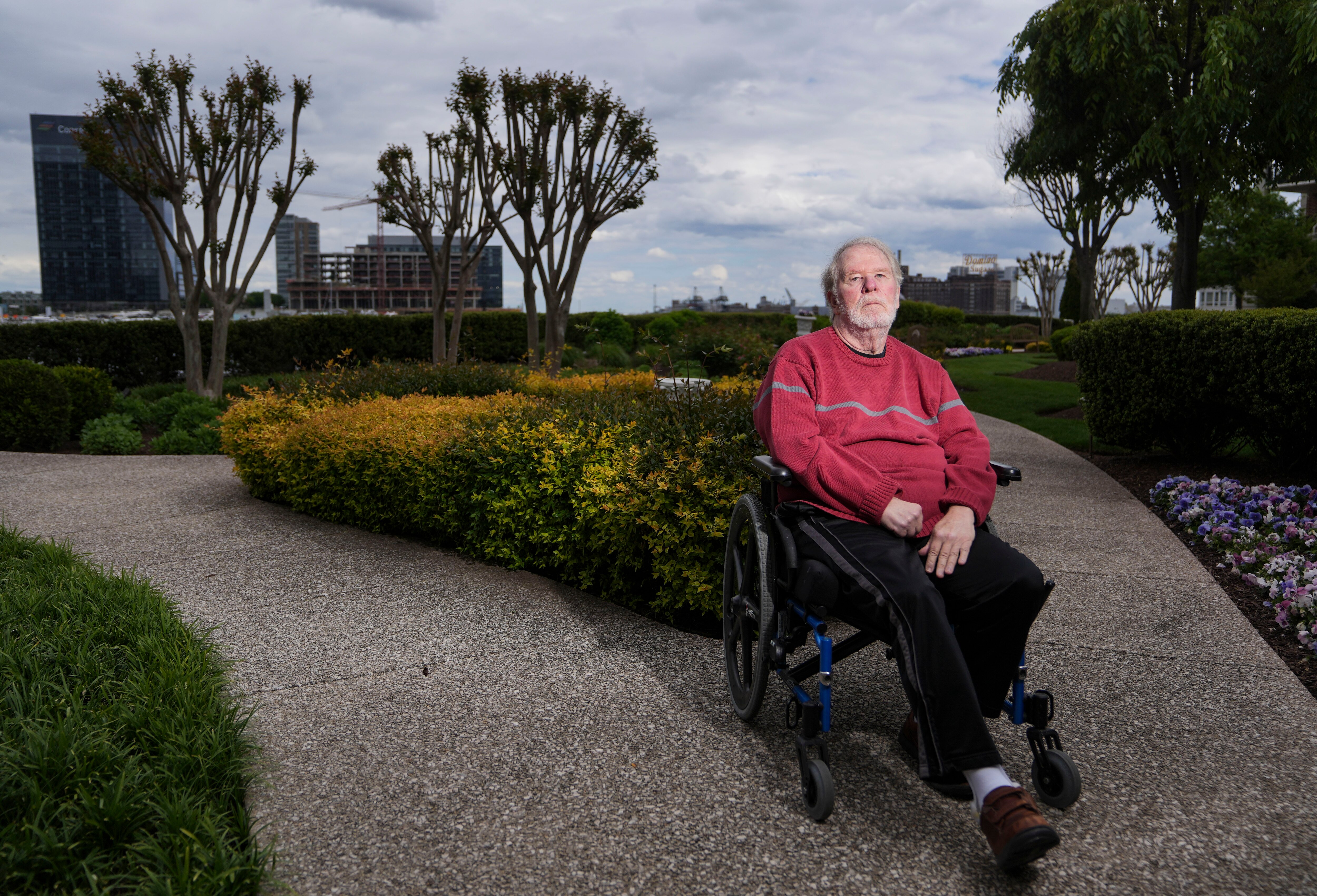 Ross Dolloff poses for a portrait in the courtyard of his home in downtown Baltimore, Monday, May 1, 2023.