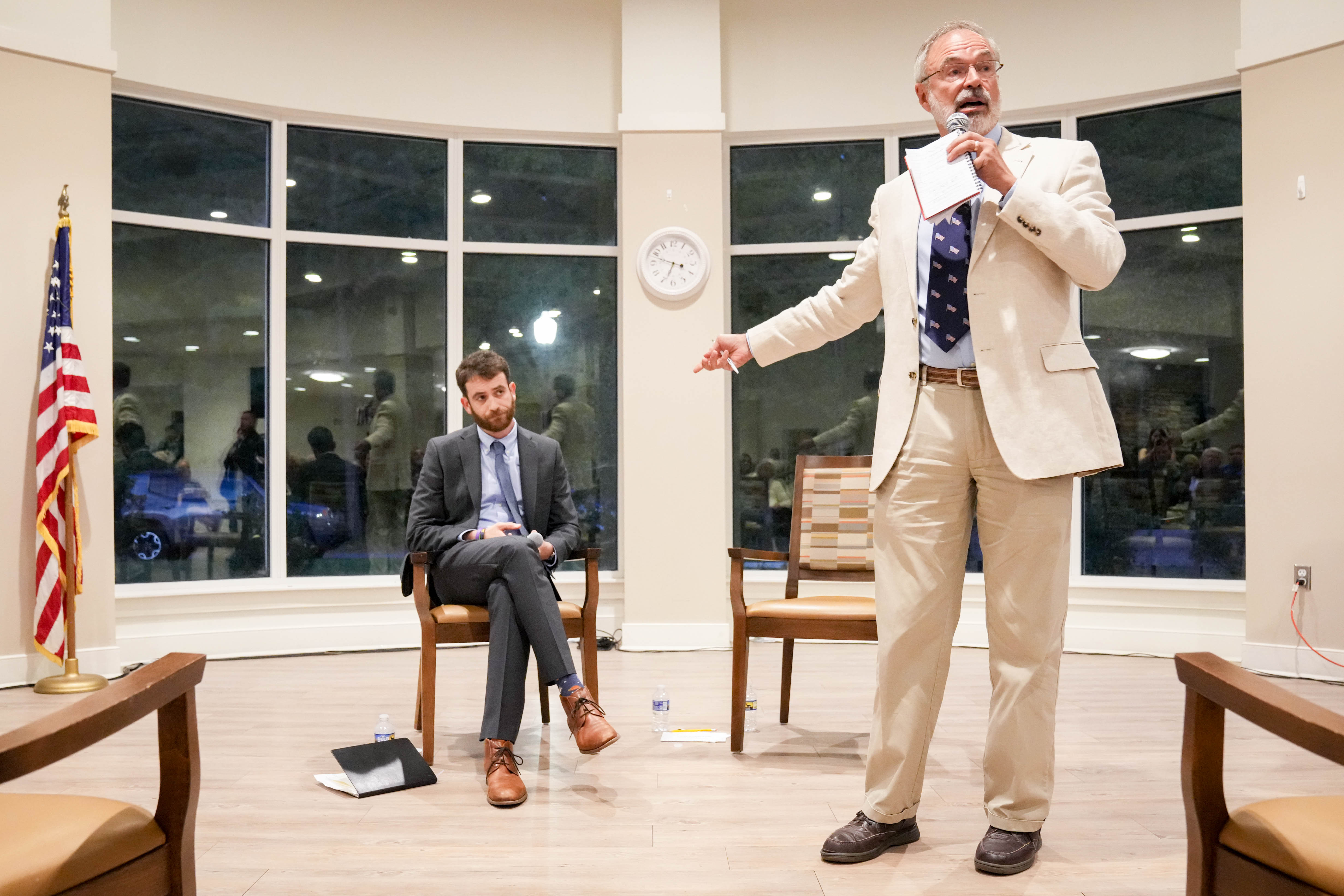 U.S. Rep. Andy Harris, right, gestures at Democratic candidate Dan Schwartz while giving remarks during a League of Women Voters forum at the Chesapeake Grove Intergenerational Center in Cambridge last week.