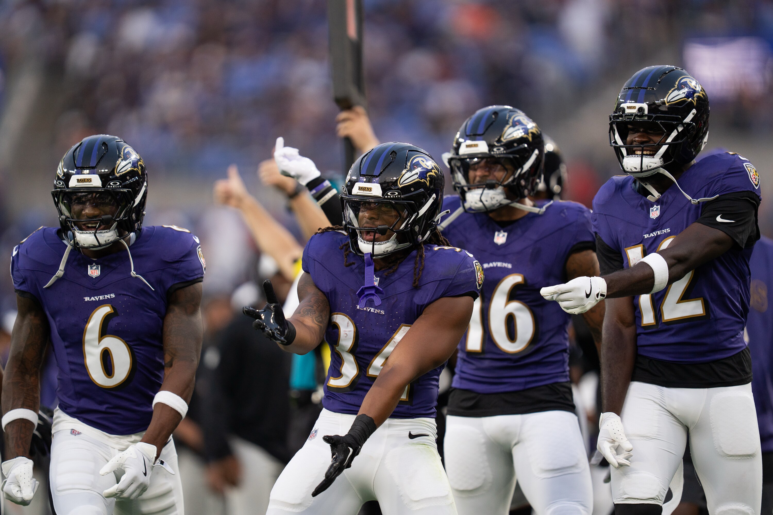 Keaton Mitchell (34) celebrates a touchdown by teammate LaJohntay Wester against the Indianapolis Colts. 