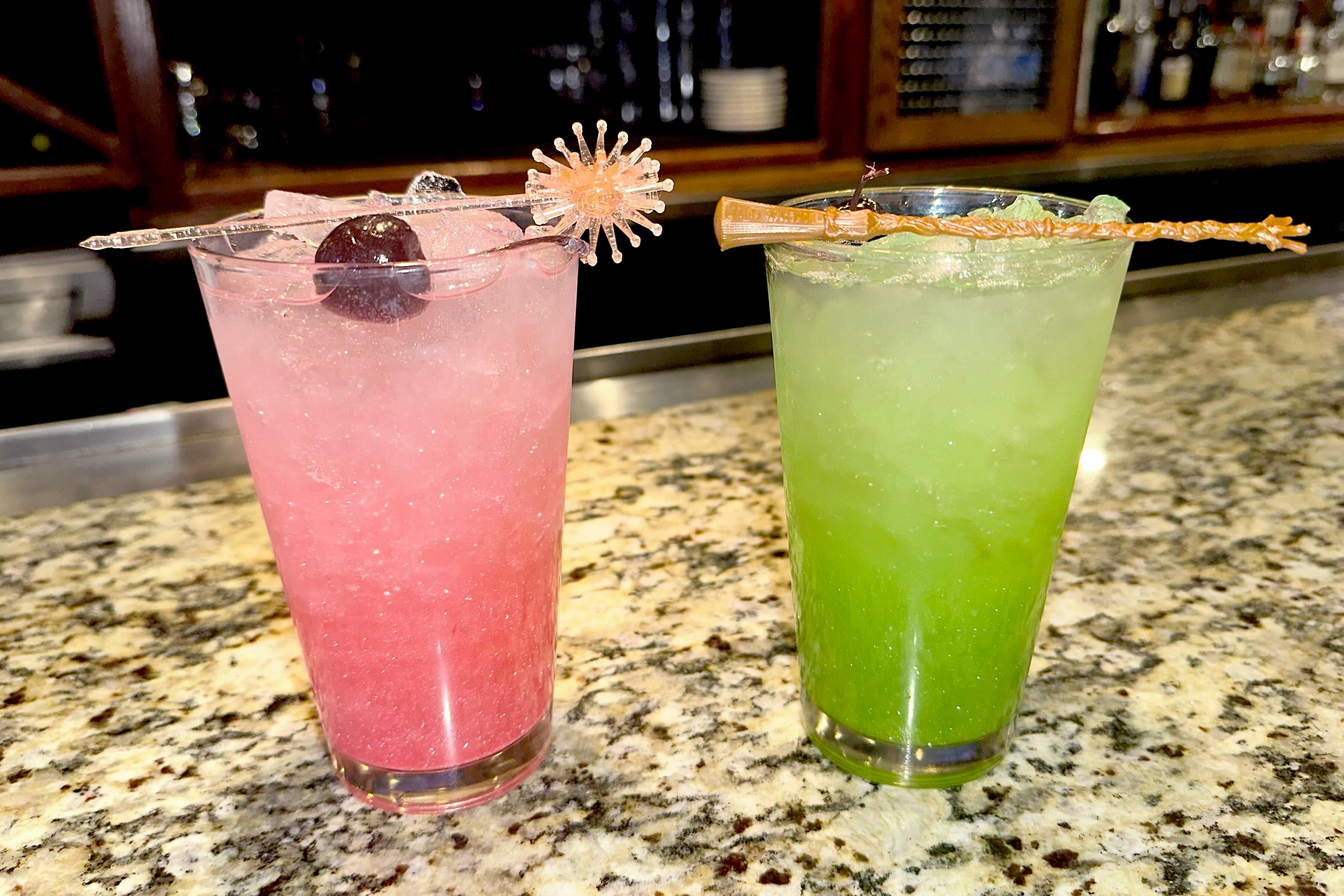 Bonefish Grill in Gaithersburg serves swankified martinis—pictured here in mocktail form, which the restaurant calls the OzNOpolitan and Emerald City Cooler, from left to right—with matching Glinda and Elphaba prop garnishes.