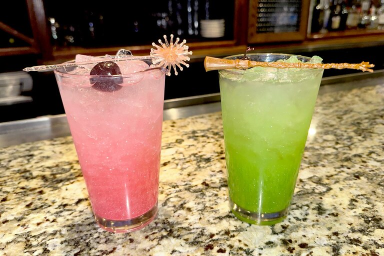 Bonefish Grill in Gaithersburg serves swankified martinis—pictured here in mocktail form, which the restaurant calls the OzNOpolitan and Emerald City Cooler, from left to right—with matching Glinda and Elphaba prop garnishes.
