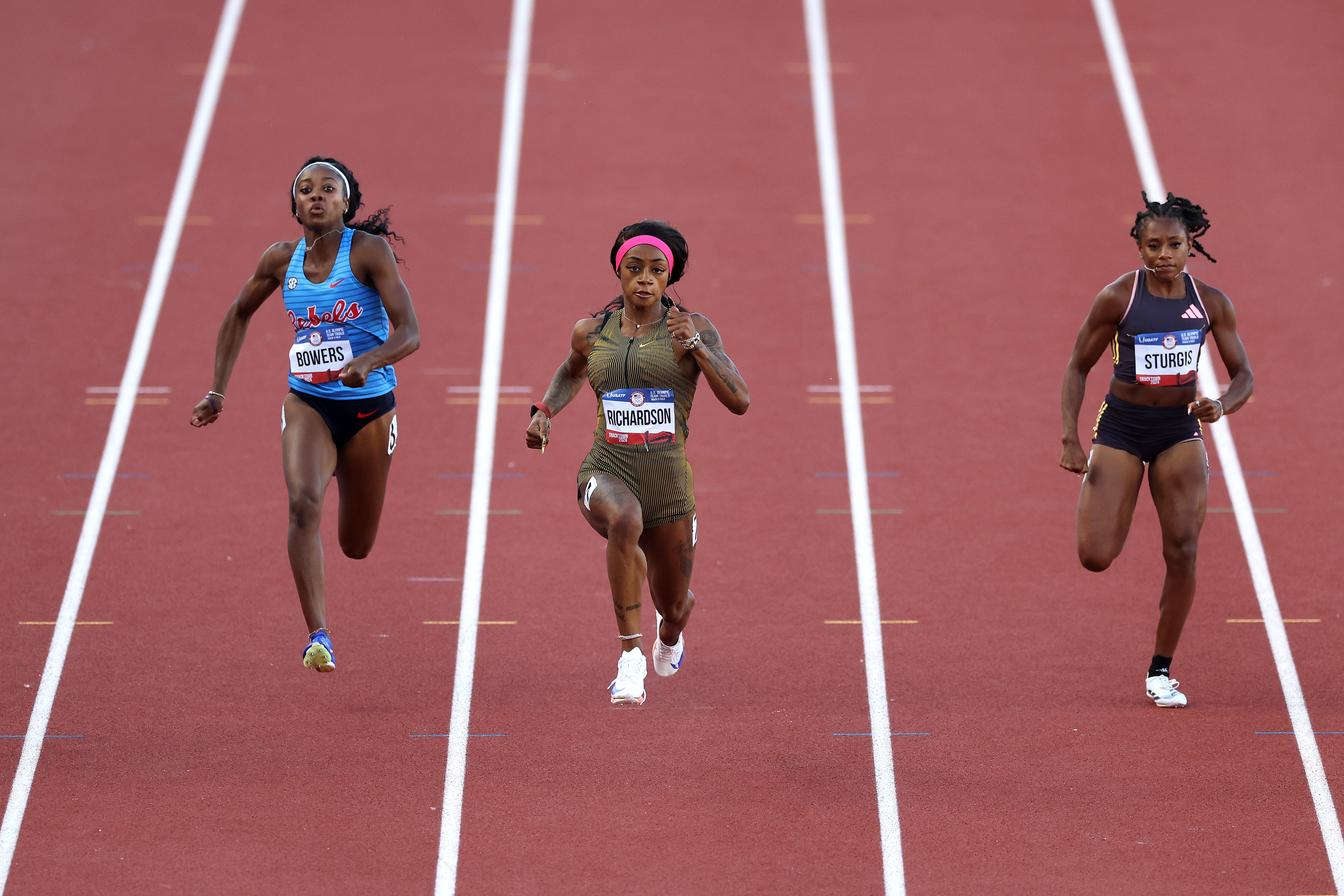 Jahniya Bowers (left), Sha'Carri Richardson (center) and Cambrea Sturgis run the first round of the women's 100-meter dash on the first day of the Olympic trials Friday.