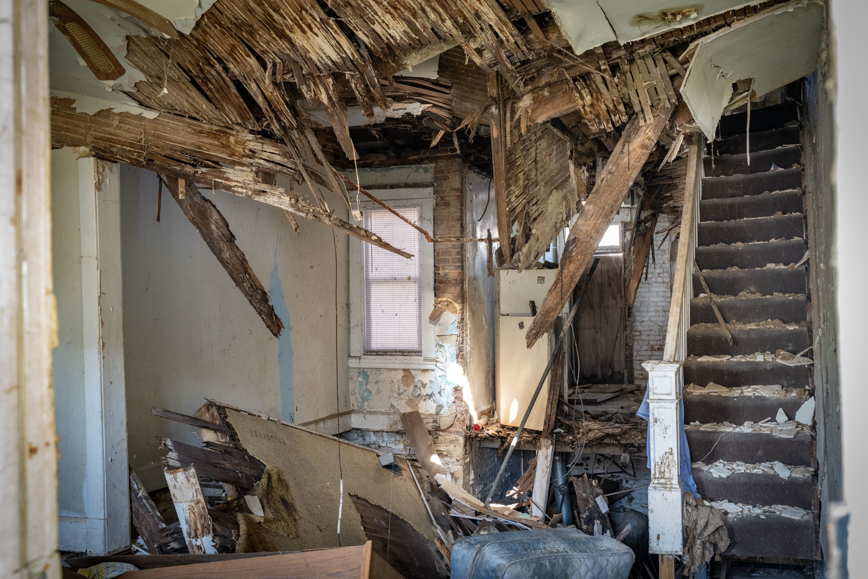 Once the plywood was removed from this vacant home on Carswell Street, the extensive damage and collapsed floors were visible. Clear boarding using polycarbonate allows for first responders to see inside without having to remove plywood.