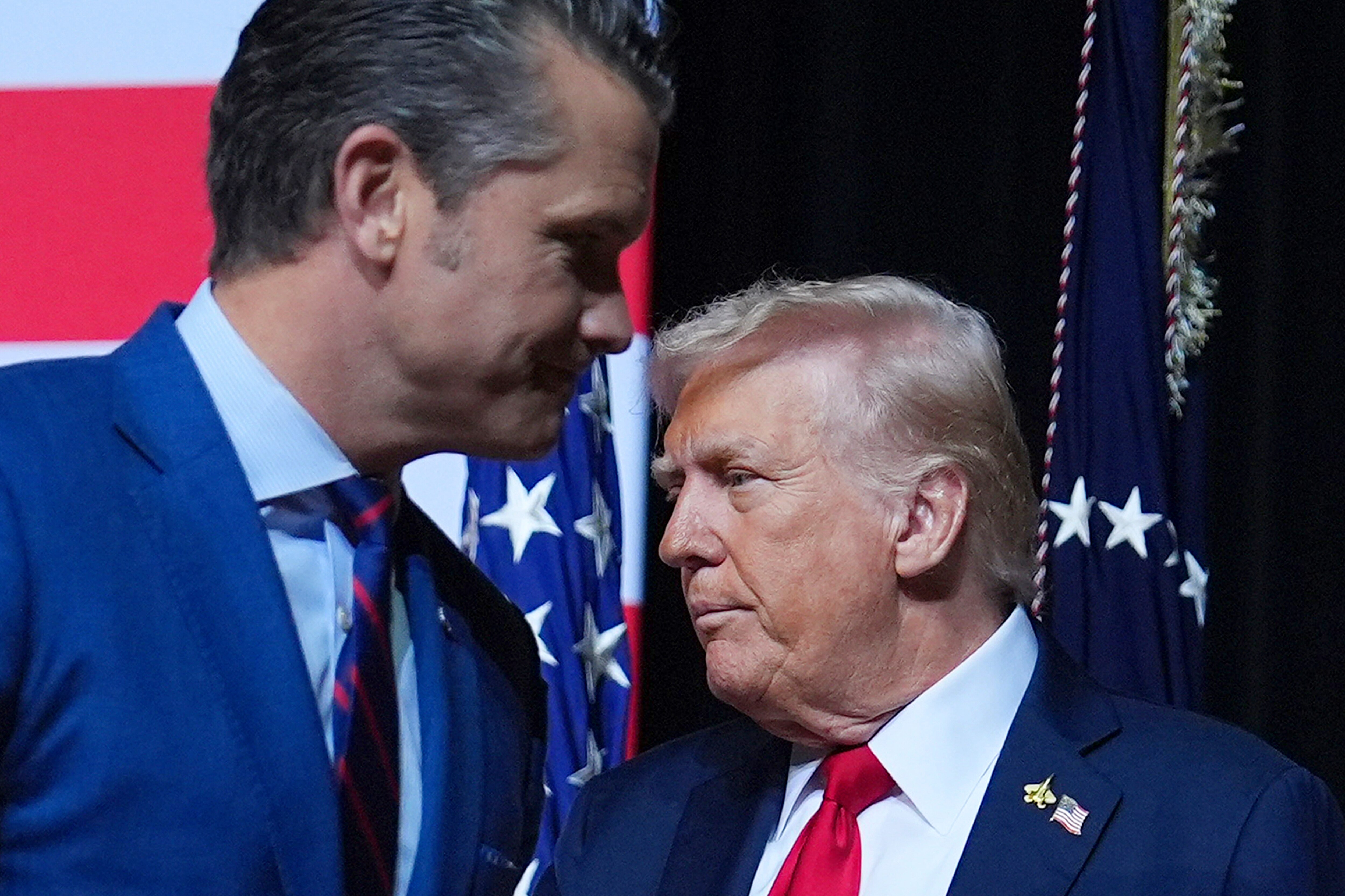 President Donald Trump is greeted by Secretary of Defense Pete Hegseth before speaking to a gathering of top U.S. military commanders at Marine Corps Base Quantico, Tuesday, Sept. 30, 2025, in Quantico, Va.