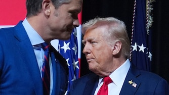 President Donald Trump is greeted by Secretary of Defense Pete Hegseth before speaking to a gathering of top U.S. military commanders at Marine Corps Base Quantico, Tuesday, Sept. 30, 2025, in Quantico, Va.