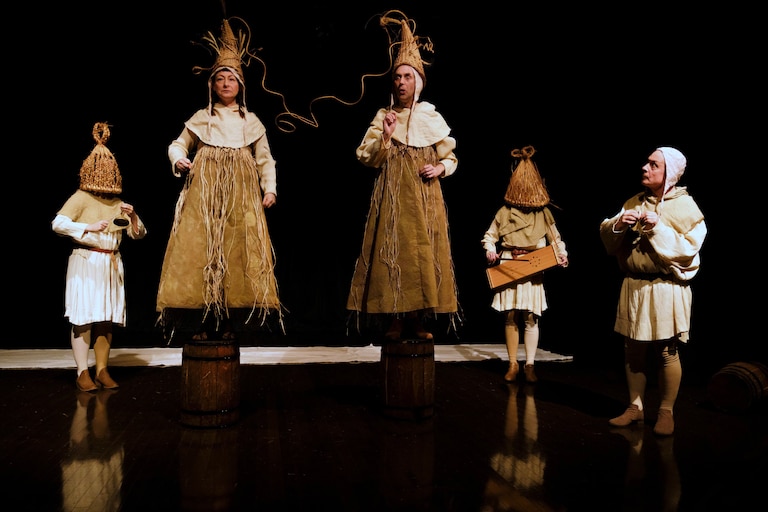Two spiritual guides (second and third from left) don cornucopia-esque hats to channel an all-knowing oracle as they field existential questions from the audience.
