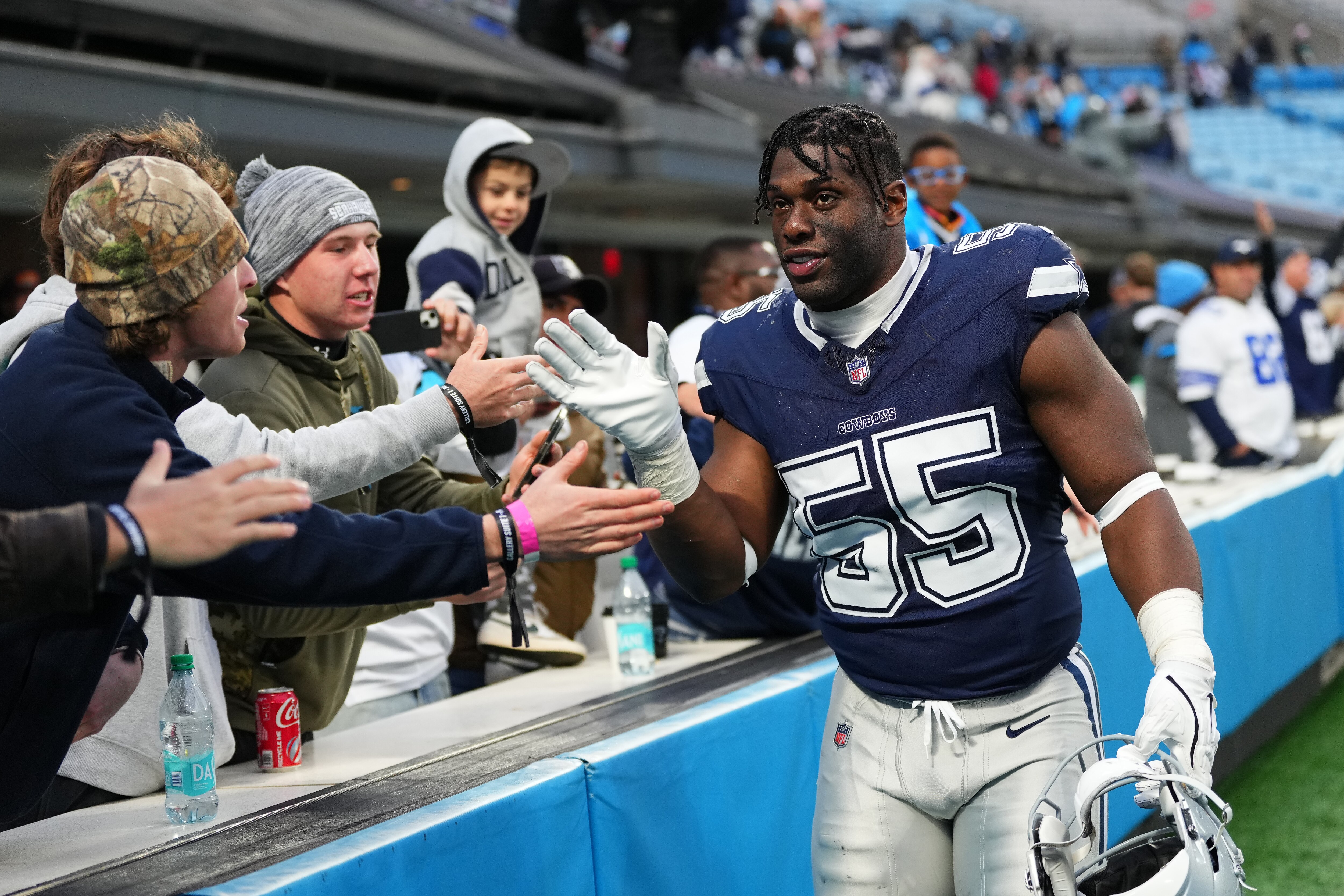 Carl Lawson celebrates with fans as a member of the Dallas Cowboys after beating the Carolina Panthers in 2024.