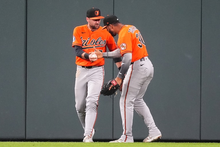 Baltimore Orioles right fielder Leody Taveras, right, congratulates center fielder Colton Cowser after he robbed Colorado Rockies' Jake McCarthy of a two-run, walkoff home run to end the ninth inning.