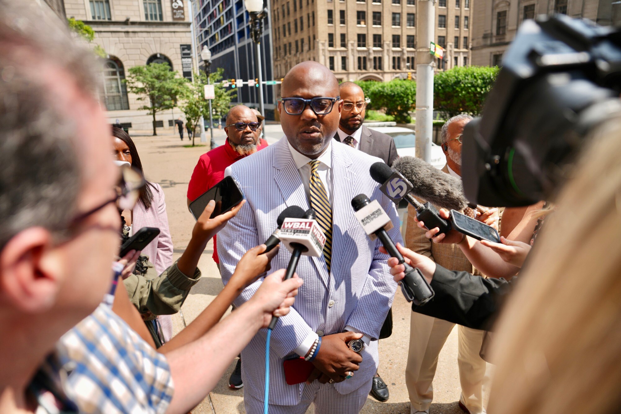 J. Wyndal Gordon, center, an attorney who's representing a 16-year-old charged with first-degree murder in the deadly shooting of Timothy Reynolds, speaks to reporters on Wednesday outside the Clarence M. Mitchell Jr. Courthouse in Baltimore. Reynolds, 48, of Hampden, was fatally shot after 4:30 p.m. at the intersection of Light and Conway streets near the Inner Harbor after confronting a group of squeegee workers with a baseball bat.
