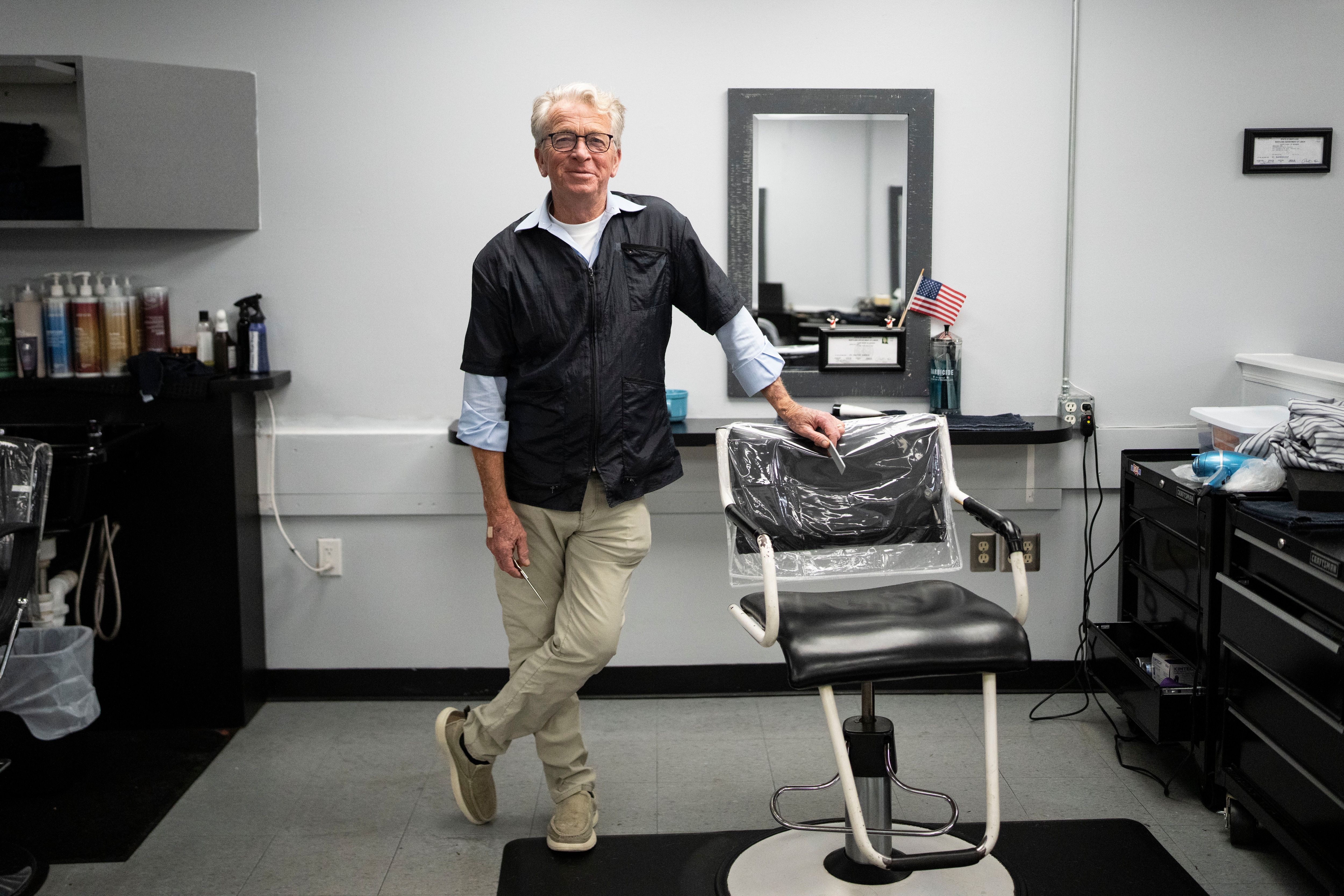 Glenn Boller, one of the owners of The Catonsville Hair Company poses for a portrait inside of the salon, in Catonsville, Tuesday, August 18, 2026.