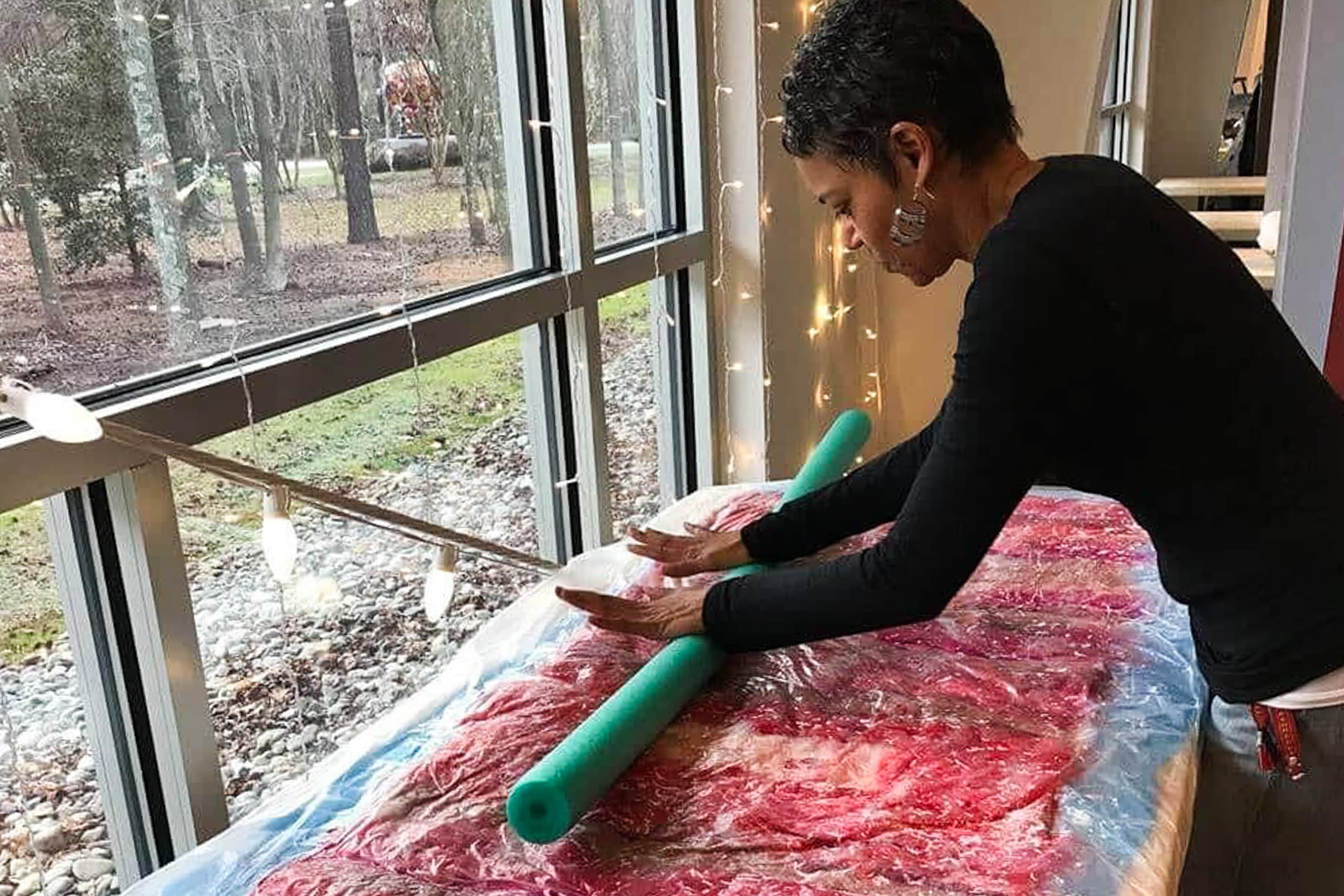 Felicia L. Reed, a Maryland fiber artist, at work in her home studio. Her latest exhibit, "Rewoven," opens at Rockville's Artists and Makers Studios on Jan. 7.