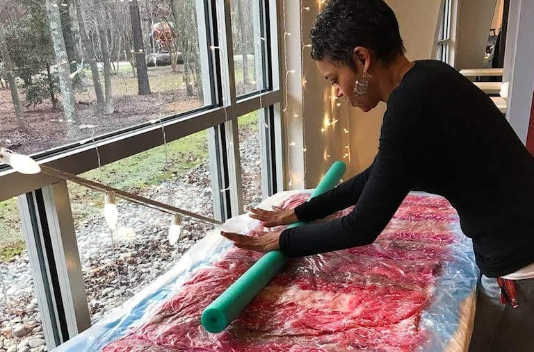 Felicia L. Reed, a Maryland fiber artist, at work in her home studio. Her latest exhibit, "Rewoven," opens at Rockville's Artists and Makers Studios on Jan. 7.
