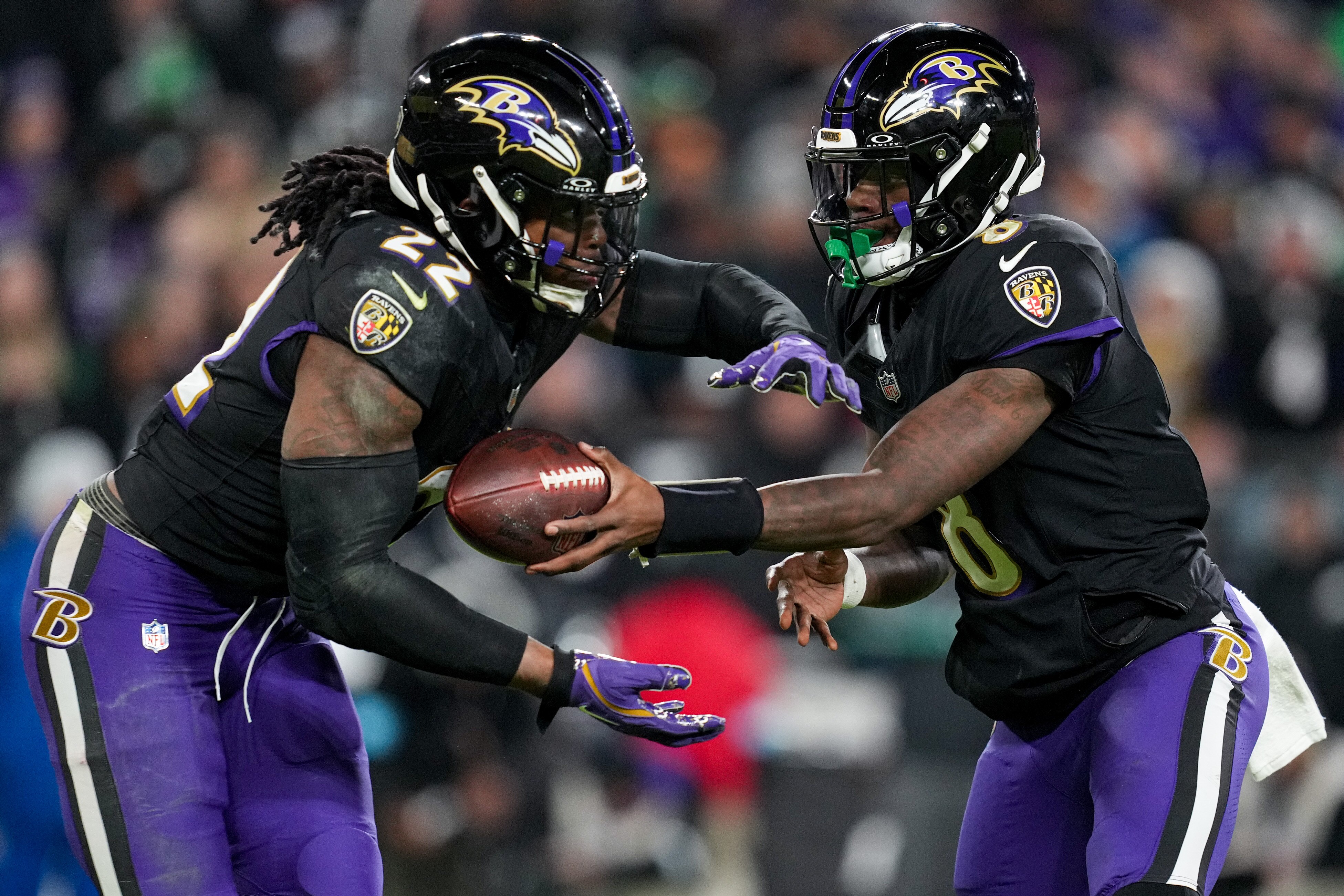 Baltimore Ravens quarterback Lamar Jackson (8) hands the ball off to running back Derrick Henry (22) during a game against the Philadelphia Eagles at M&T Bank Stadium in Baltimore, Md. on Sunday, December 1, 2024.