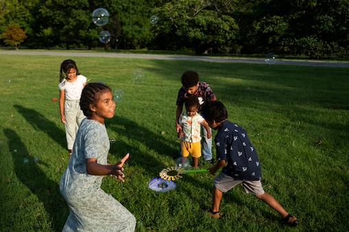 Lilac, 10, of Baltimore pops bubbles with her siblings behind her during Baltimore City Rec & Parks event at Cylburn Arboretum in Baltimore, Thursday, September 3, 2026. The event announced the Baltimore's new city tree, which will replace the invasive Callery pear.