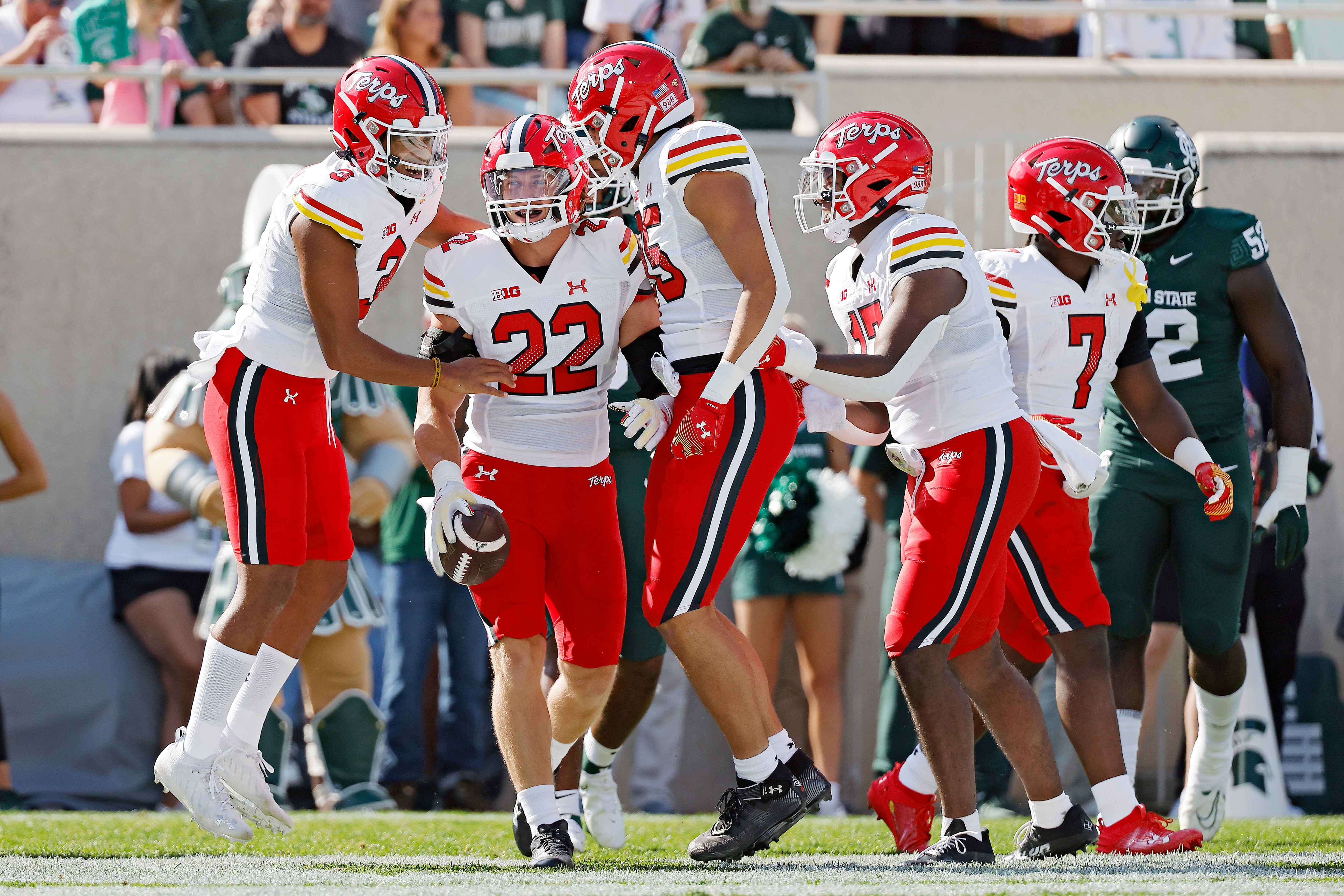 Sean Greeley, No. 22 of the Maryland Terrapins, celebrates with teammates after scoring a touchdown in the first quarter of a game against the Michigan State Spartans at Spartan Stadium on Sept. 23, 2023 in East Lansing, Michigan.