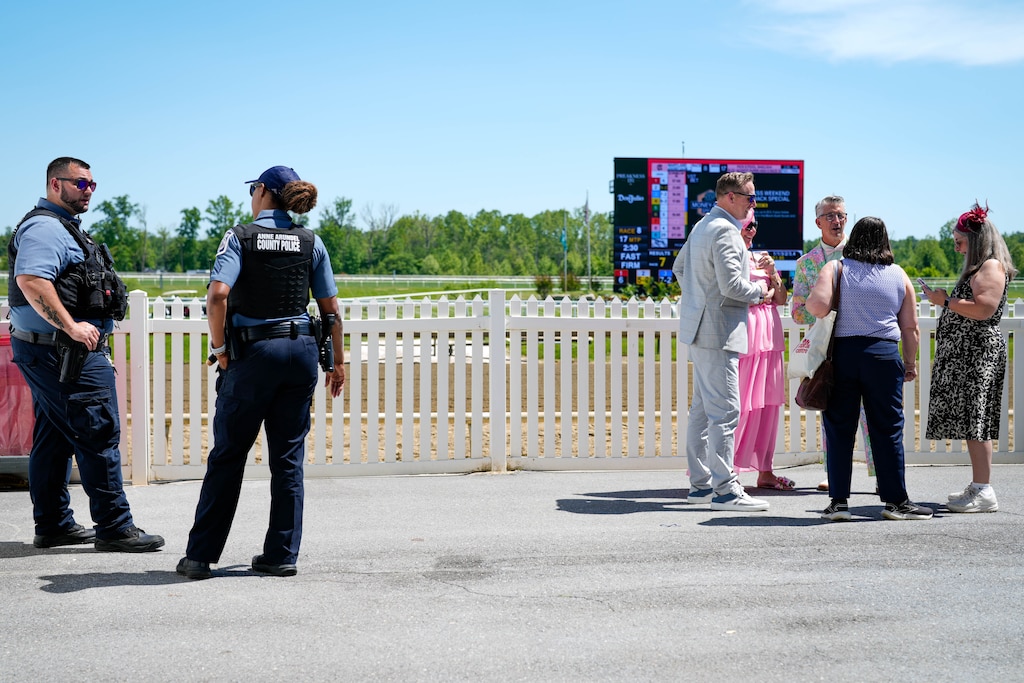 Anne Arundel County Police officers, left, observe the crowd during the 151st Preakness at Laurel Park racetrack on Saturday, May 16, 2026.