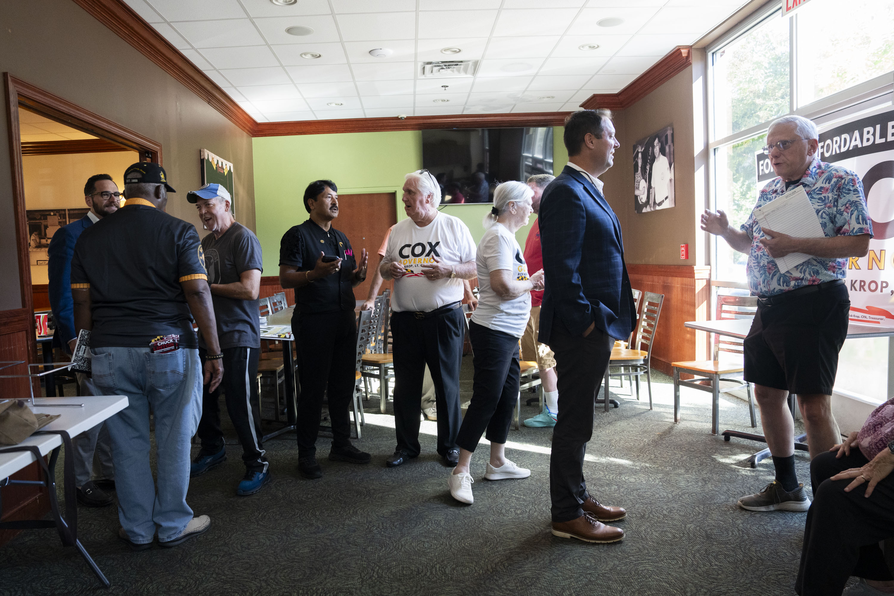 Bob Cockey, center, a former Republican who ran as a moderate Democrat for Howard County executive, attends a community meet-and-greet for Dan Cox, the Republican candidate for governor, in Columbia last month.