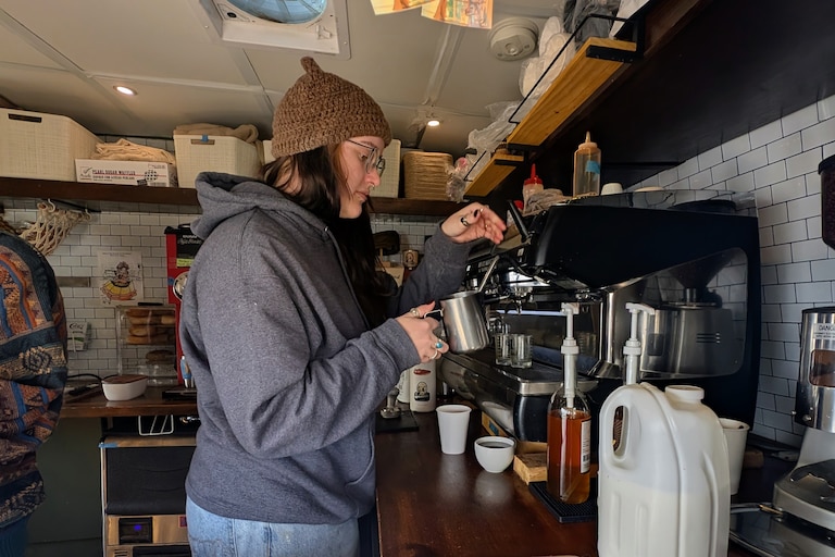 Cat Rowland pulls an espresso shot from the coffee machine inside Oscars Coffee in Annapolis, tucked inside a converted camper.