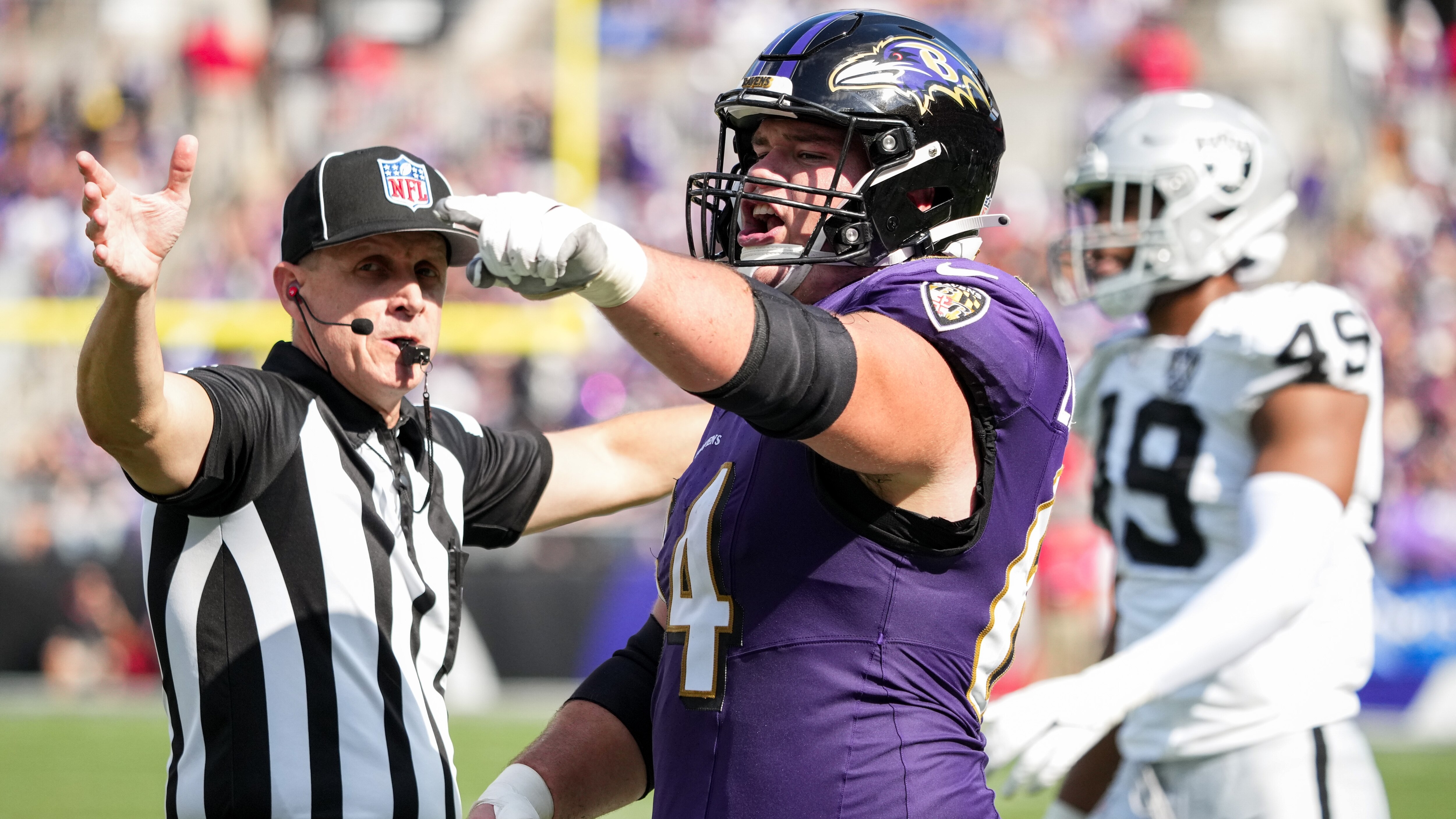 Baltimore Ravens center Tyler Linderbaum (64) shouts at the defense after they earned a flag for a personal foul on Derrick Henry’s run during their home opener against the Las Vegas Raiders at M&T Bank Stadium in Baltimore on Sunday, September 15, 2024.