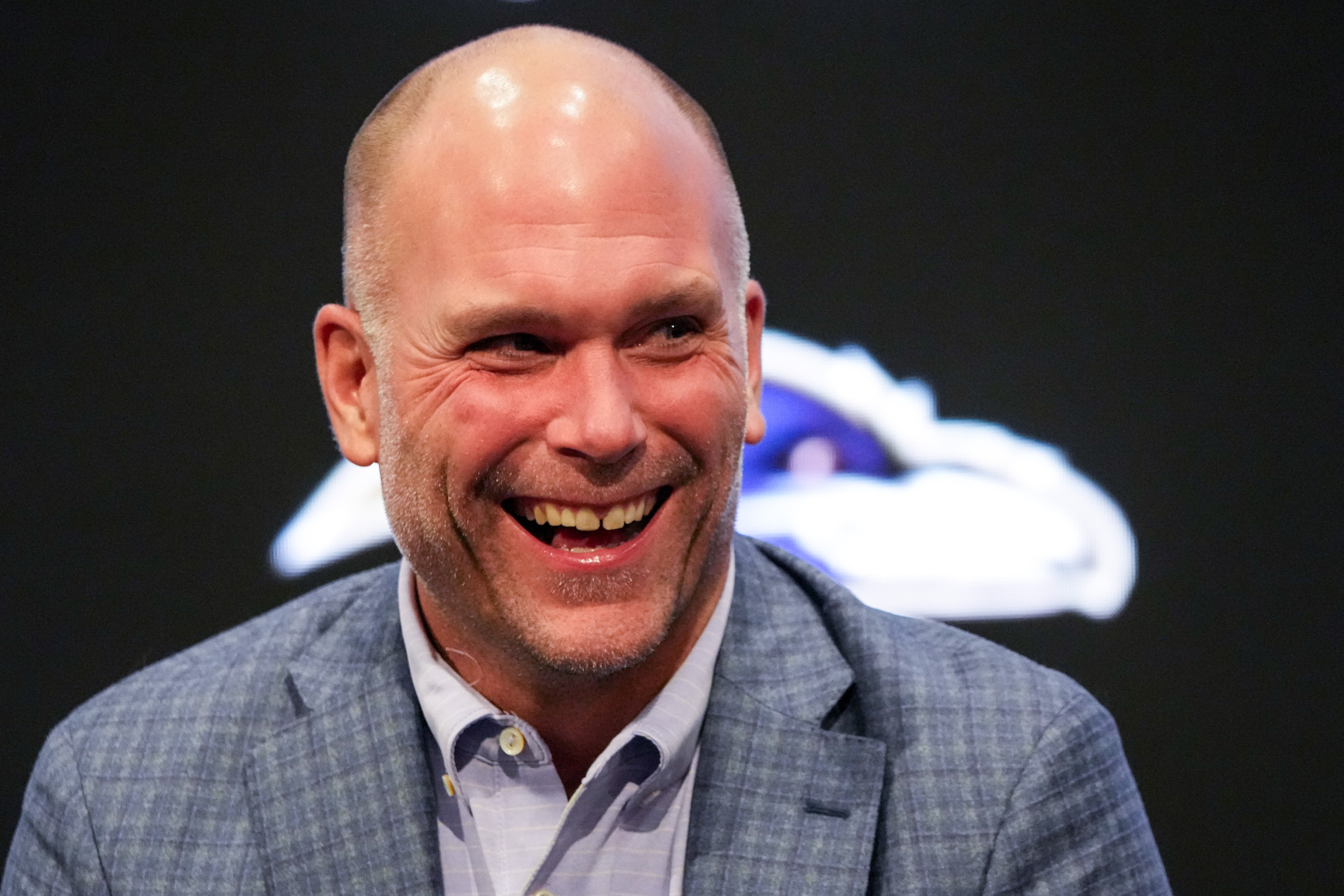 Baltimore Ravens general manager Eric DeCosta laughs during a news conference in March 2024.