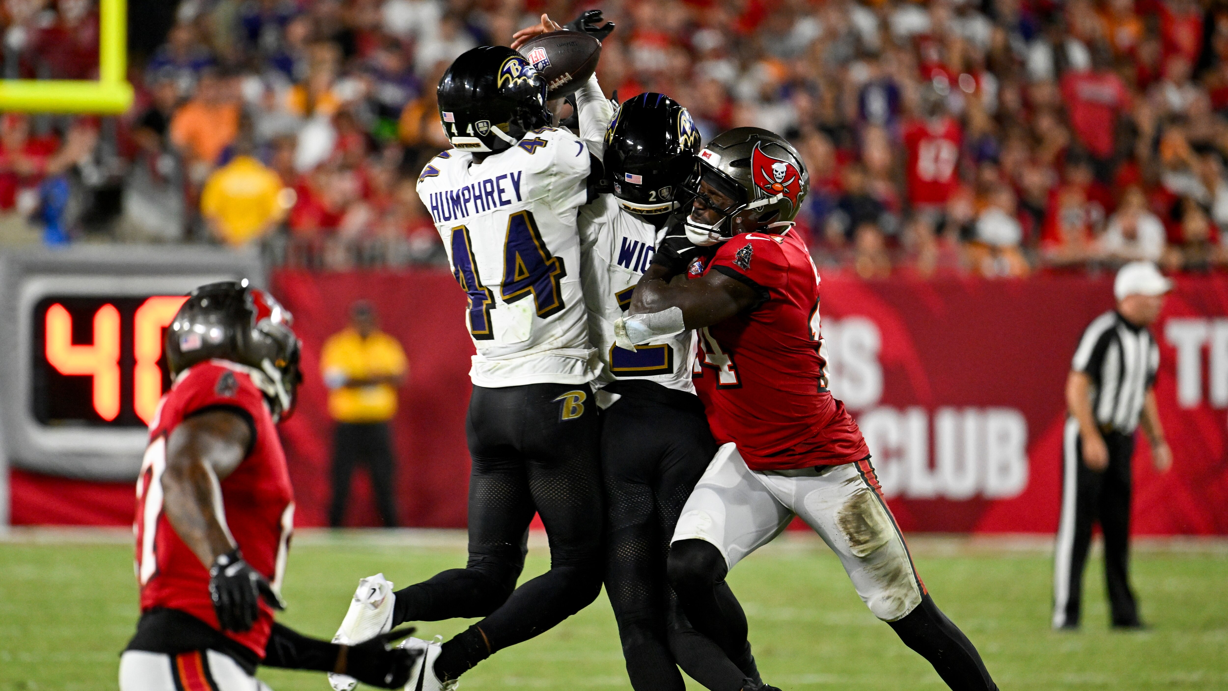 Baltimore Ravens cornerback Marlon Humphrey (44) intercepts a pass intended for Tampa Bay Buccaneers wide receiver Chris Godwin (14) during the first half of an NFL football game, Monday, Oct. 21, 2024, in Tampa, Fla. (AP Photo/Jason Behnken)