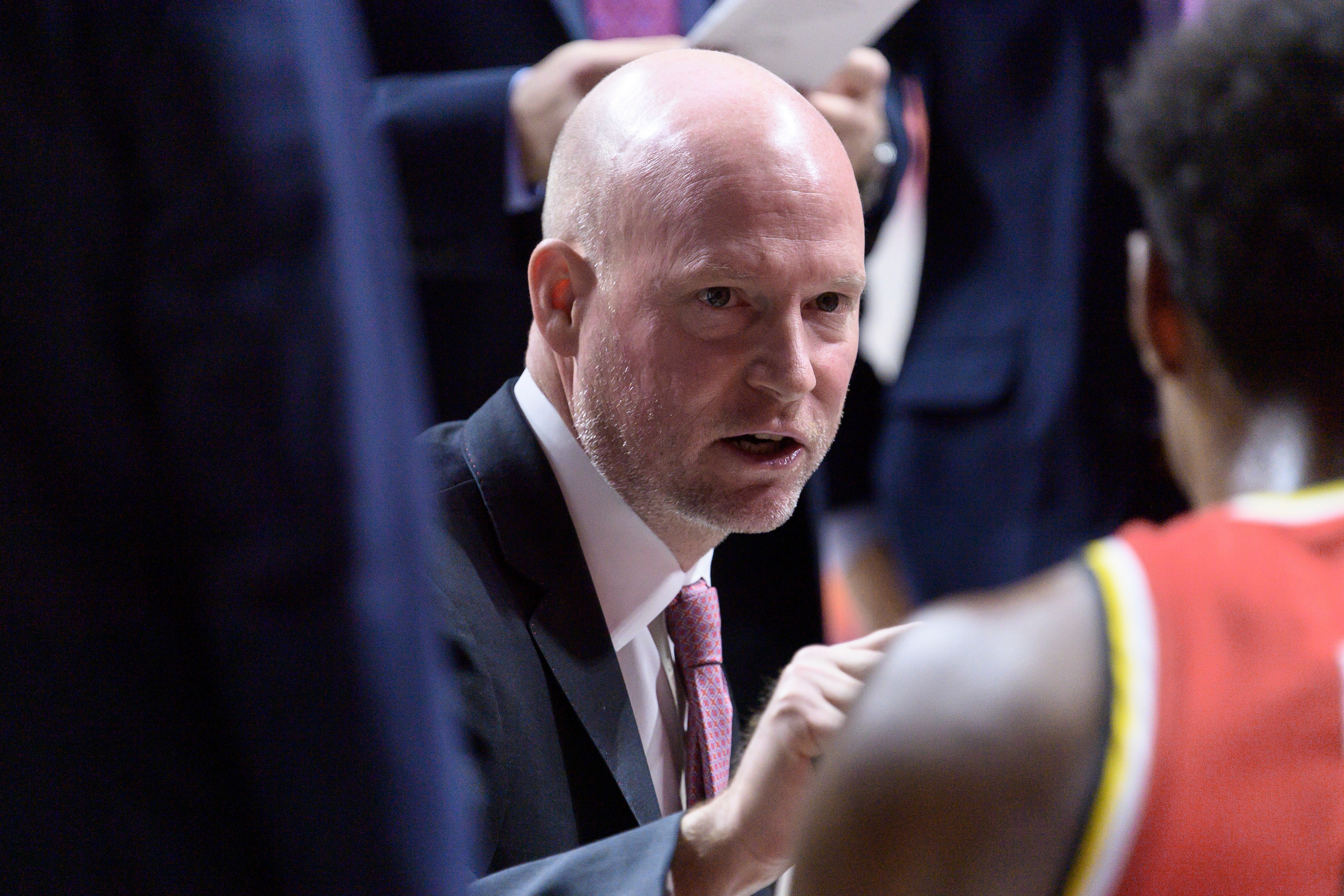 Maryland head coach talks with his team in the huddle during a game against Illinois.