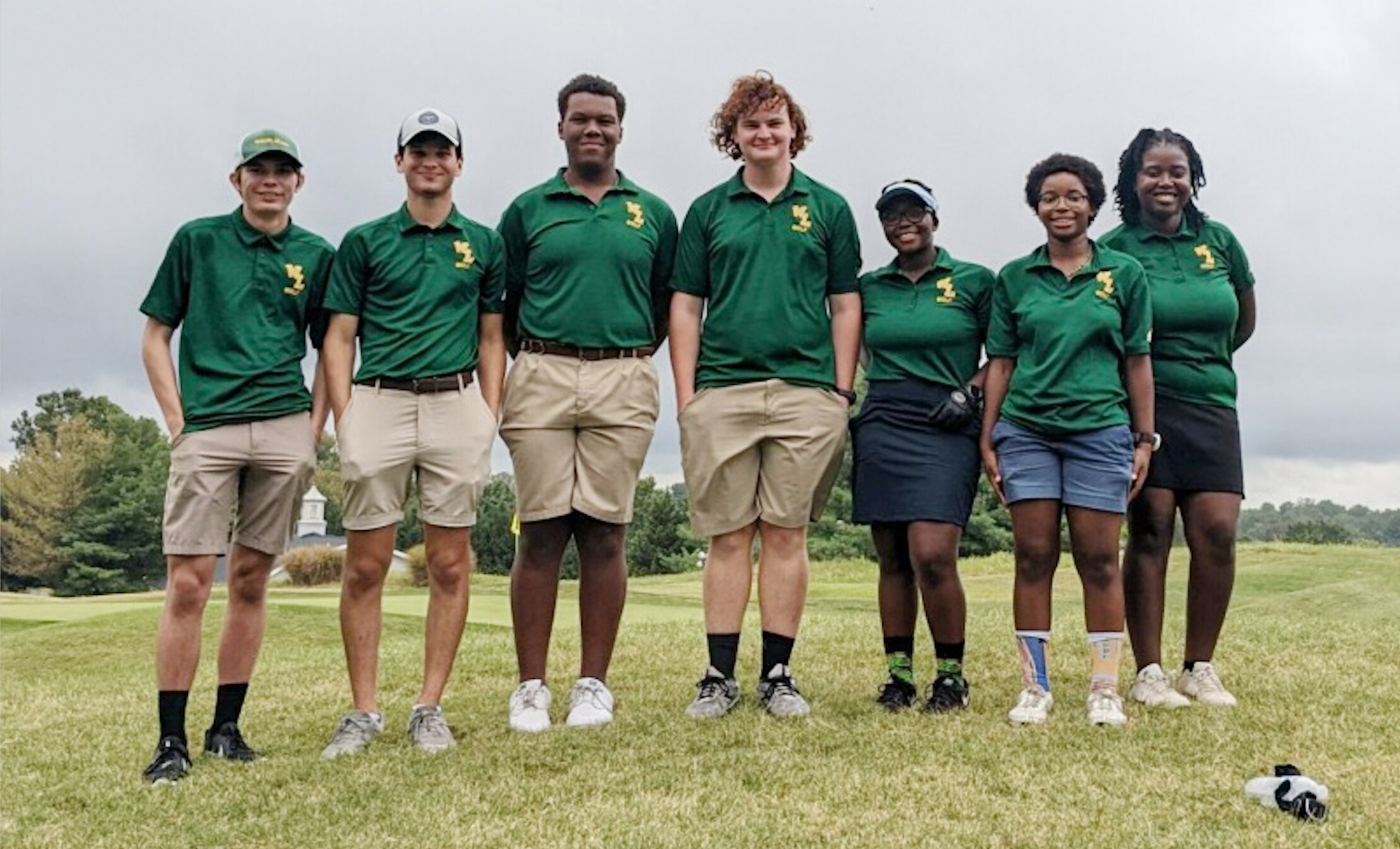The Wilde Lake golf team poses for a photo together next to the ninth green at Fairway Hills on Wednesday afternoon.